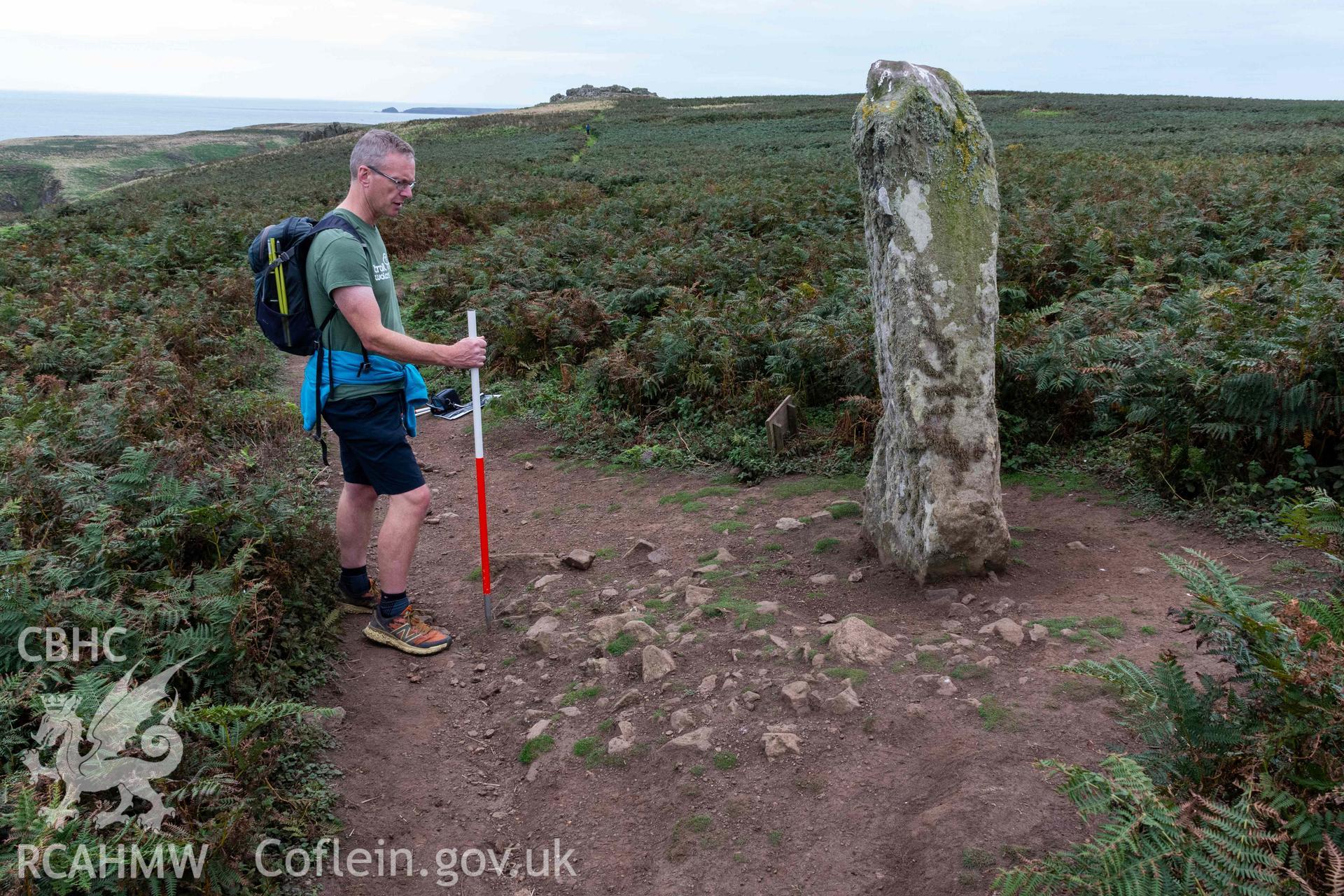 Harold Stone Standing Stone. View from the north taken 03/09/2024 showing exposed stone surface on the east side of the stone (with scale).