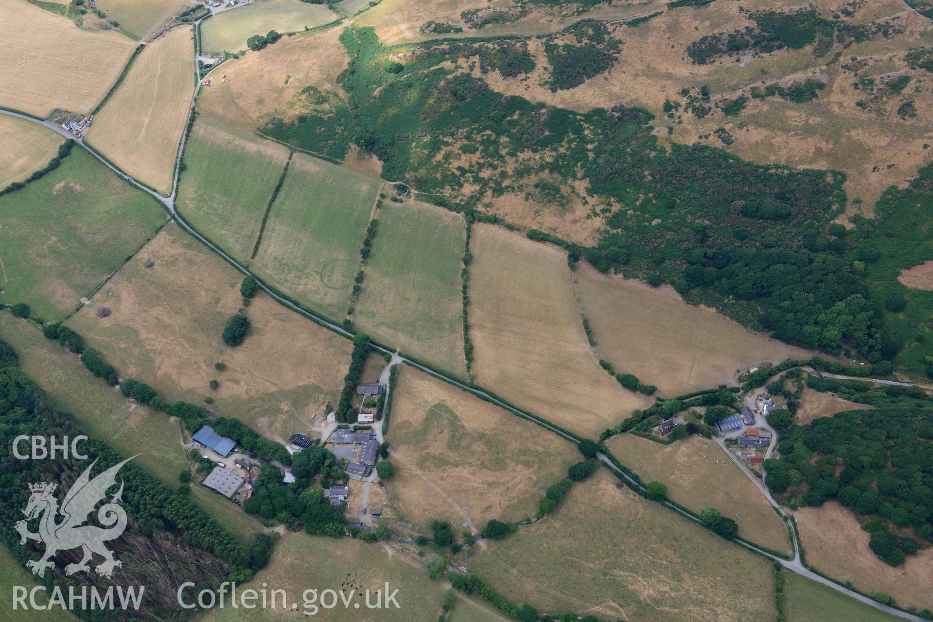 Ringditch cropmark and round barrow at Dyffryn Gwyn. Oblique aerial photograph taken during the Royal Commission’s programme of archaeological aerial reconnaissance by Toby Driver on 10 July 2018.