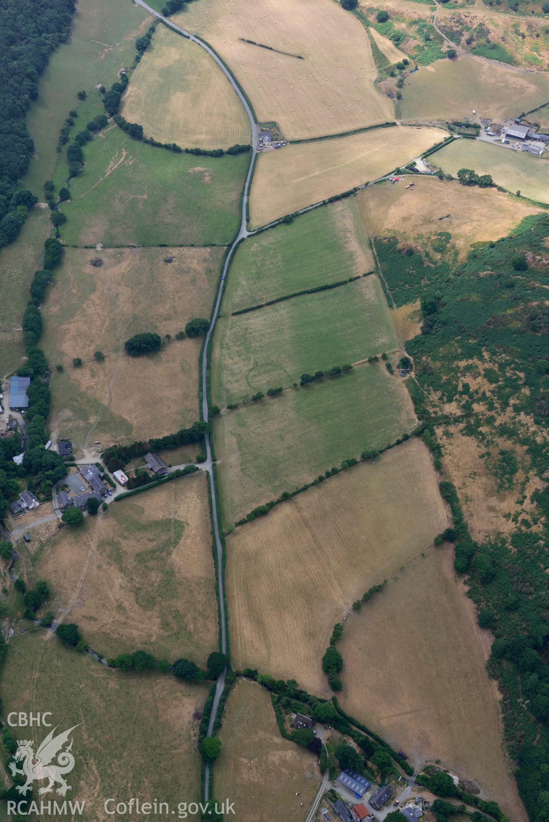 Ringditch cropmark and round barrow at Dyffryn Gwyn. Oblique aerial photograph taken during the Royal Commission’s programme of archaeological aerial reconnaissance by Toby Driver on 10 July 2018.