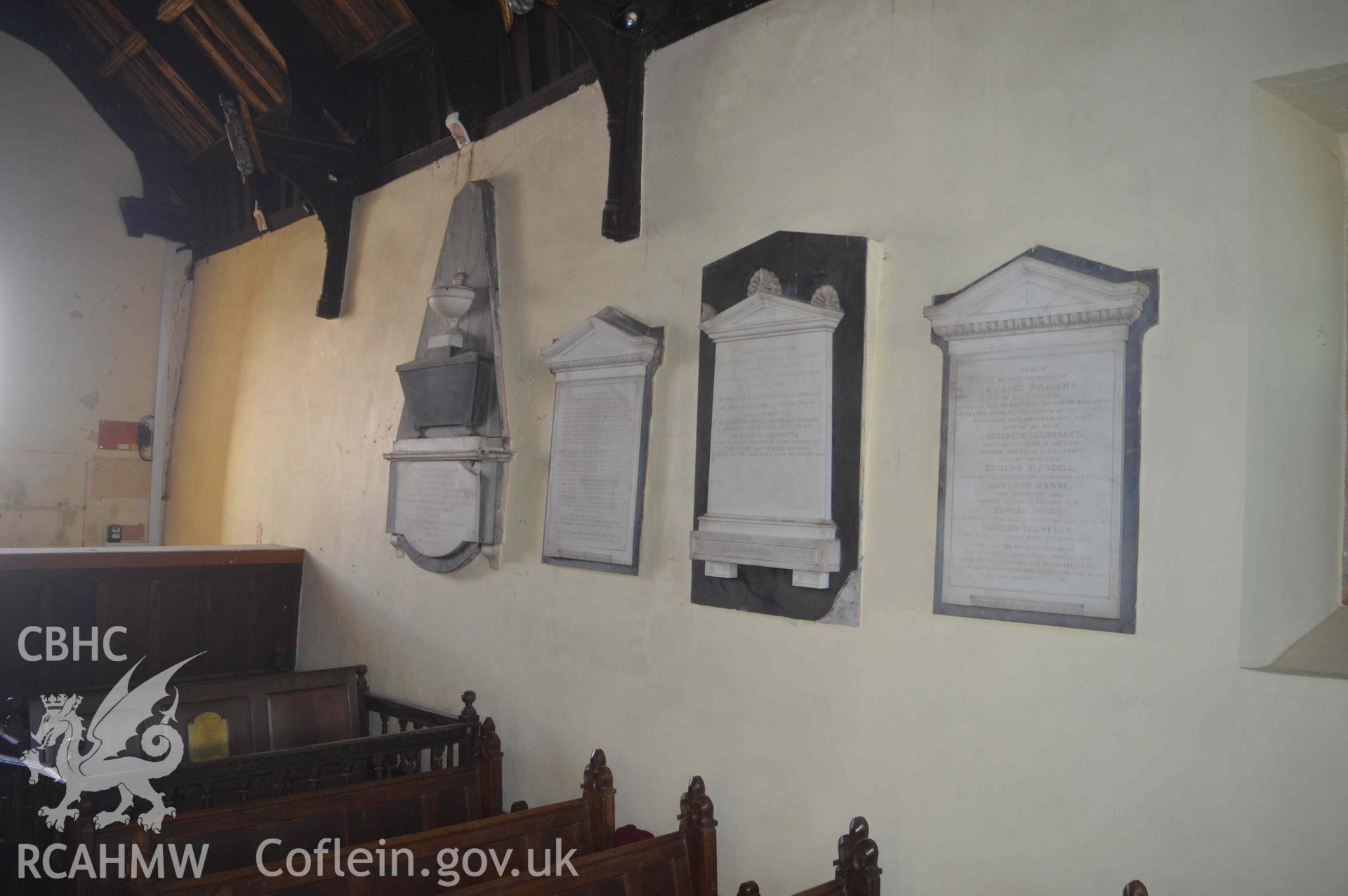 Photograph showing general view of memorials in situ on the north wall of the North Nave. From an Archaeological Survey and Watching Brief of St Cynhafal’s Church, Llangynhafal, carried out by Clwyd-Powys Archaeological Trust in 2021. Project no. 2520.