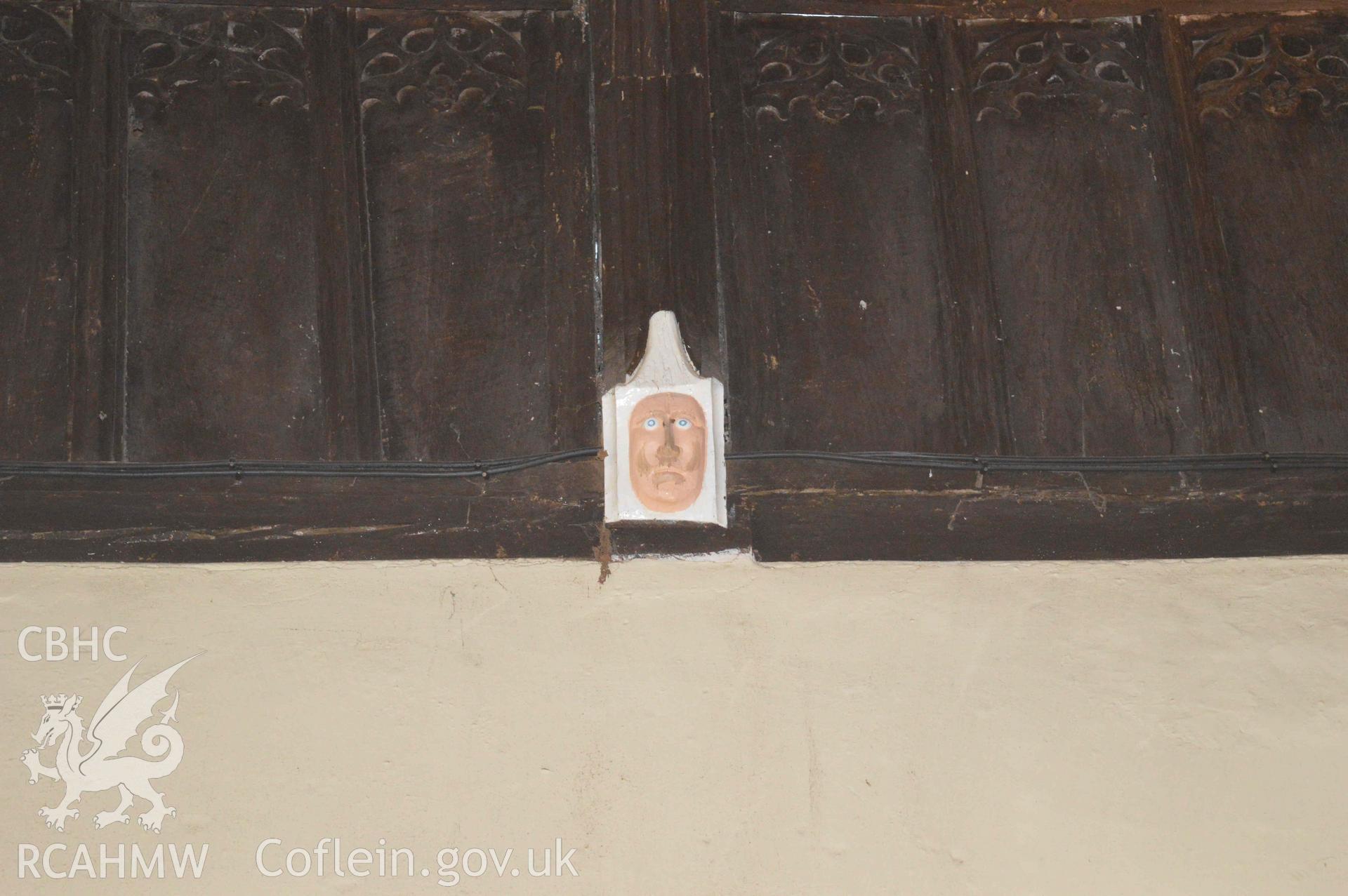 Photograph showing carved mask, one of a number of face carvings, presumed to be of 13-15th century origin, which depict bishops,
kings, the devil or bearded faces crowned with oak-leaves (possibly greenman imagery). From an Archaeological Survey and Watching Brief of St Cynhafal’s Church, Llangynhafal, carried out by Clwyd-Powys Archaeological Trust in 2021. Project no. 2520.