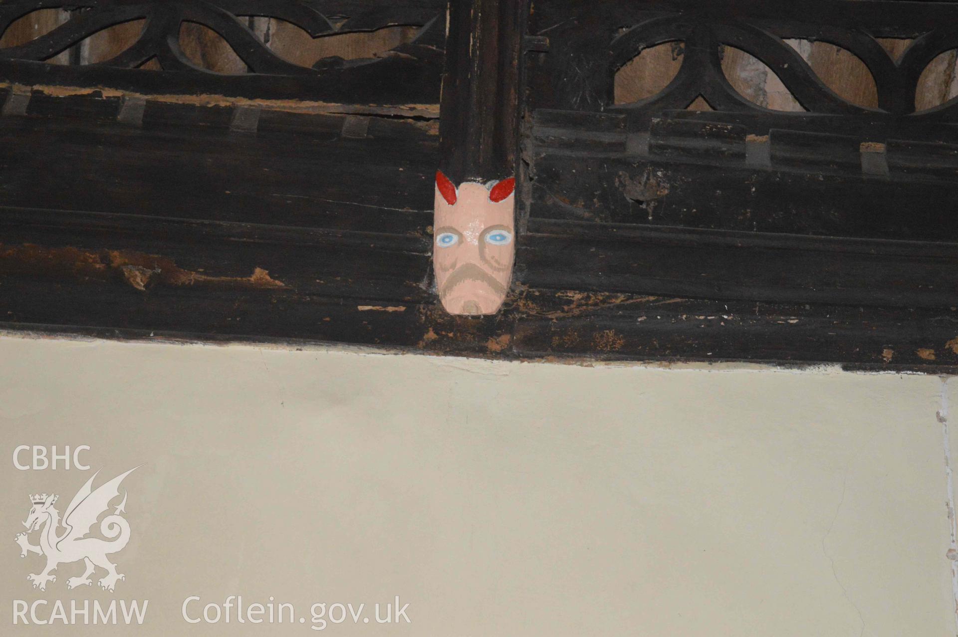 Photograph showing carved mask, one of a number of face carvings, presumed to be of 13-15th century origin, which depict bishops,
kings, the devil or bearded faces crowned with oak-leaves (possibly greenman imagery). From an Archaeological Survey and Watching Brief of St Cynhafal’s Church, Llangynhafal, carried out by Clwyd-Powys Archaeological Trust in 2021. Project no. 2520.