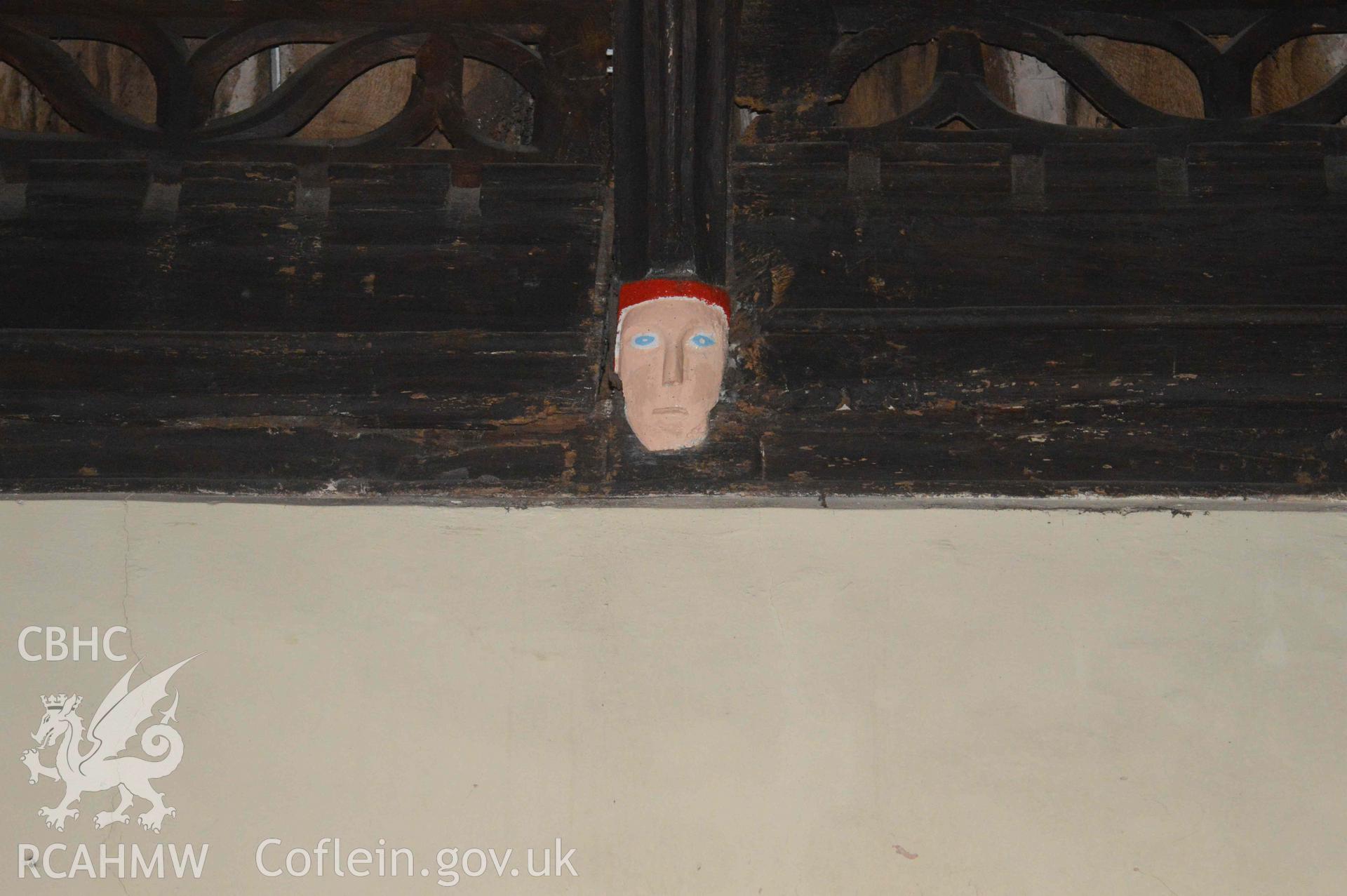 Photograph showing carved mask, one of a number of face carvings, presumed to be of 13-15th century origin, which depict bishops,
kings, the devil or bearded faces crowned with oak-leaves (possibly greenman imagery). From an Archaeological Survey and Watching Brief of St Cynhafal’s Church, Llangynhafal, carried out by Clwyd-Powys Archaeological Trust in 2021. Project no. 2520.