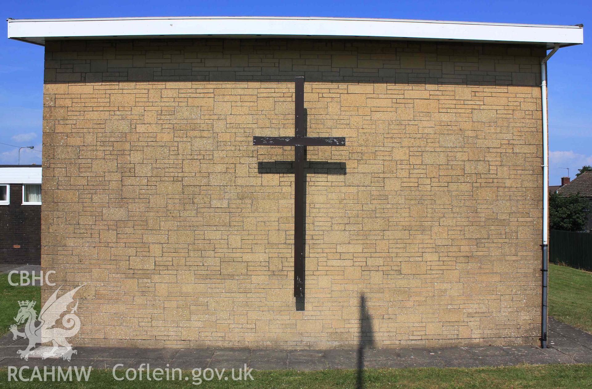 Exterior. Entrance and large cross on north west wall