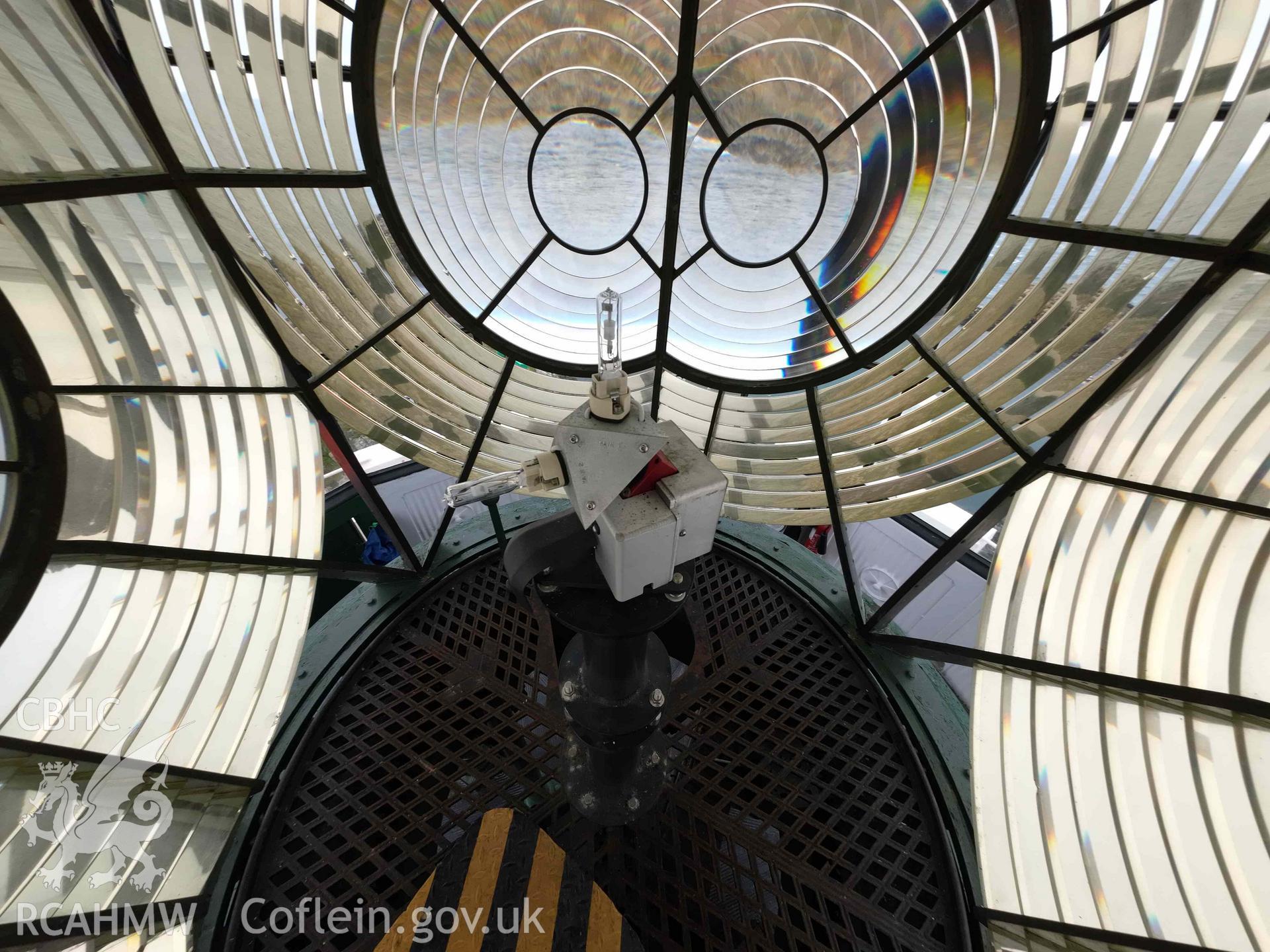 Inside of the Skerries Lighthouse Fresnel lens showing the existing lamp on 16/07/2024