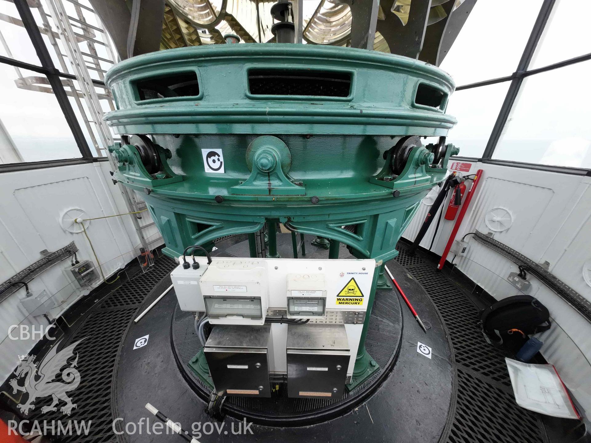 General wide-angle view of the lens pedestal within the Skerries Lighthouse lantern room on 16/07/2024, including the modern electrical circuit board.