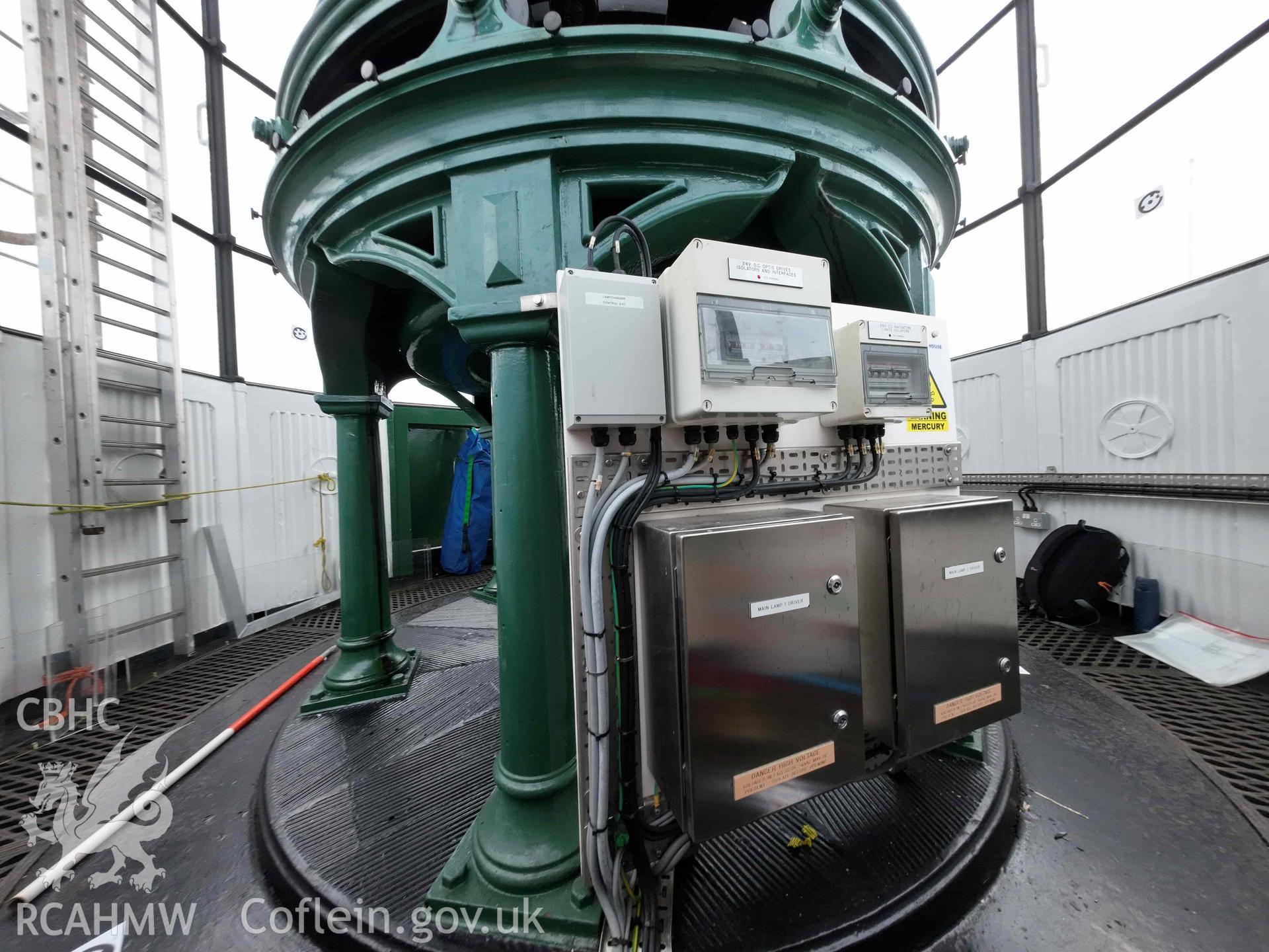 General wide-angle view of the lens pedestal within the Skerries Lighthouse lantern room on 16/07/2024, including the modern electrical circuit board.