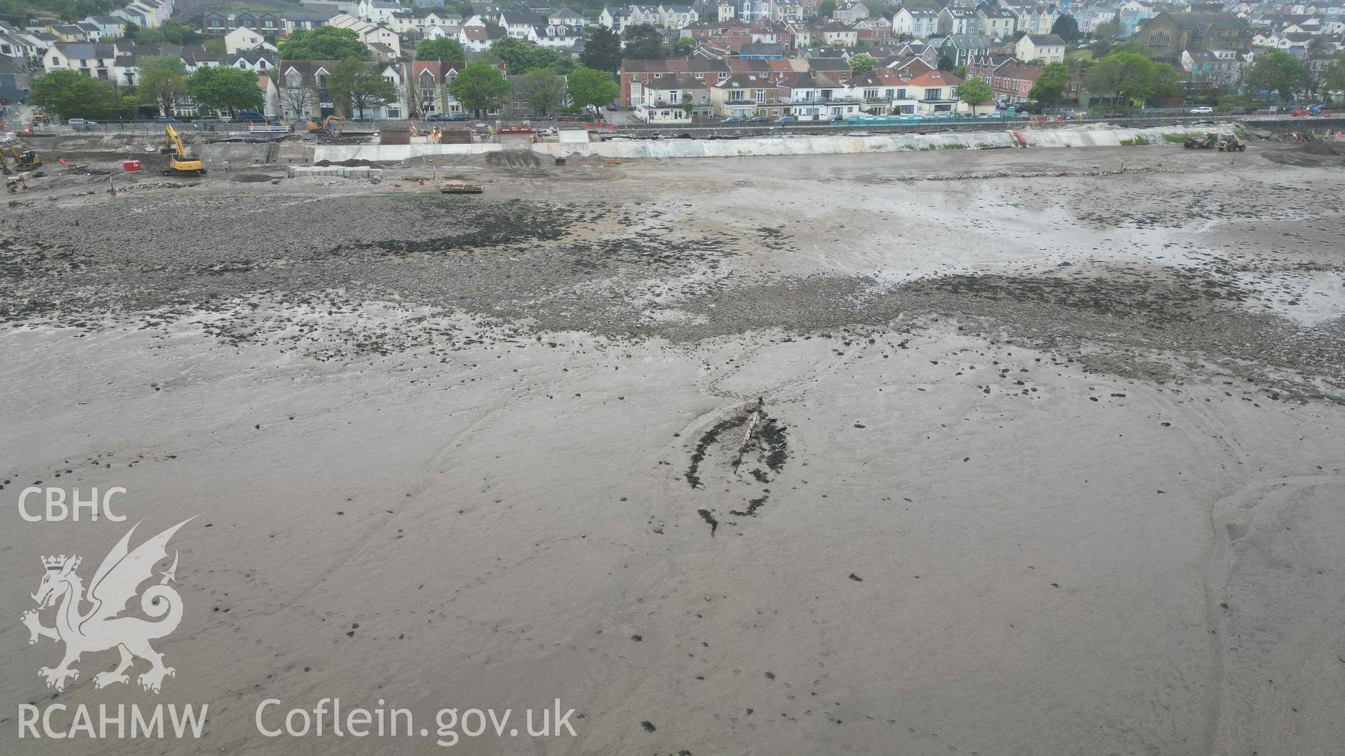 General oblique view of Mumbles Wreck 1, looking southwest, on 08/05/2024. Ongoing sea defence work can be seen in the background.