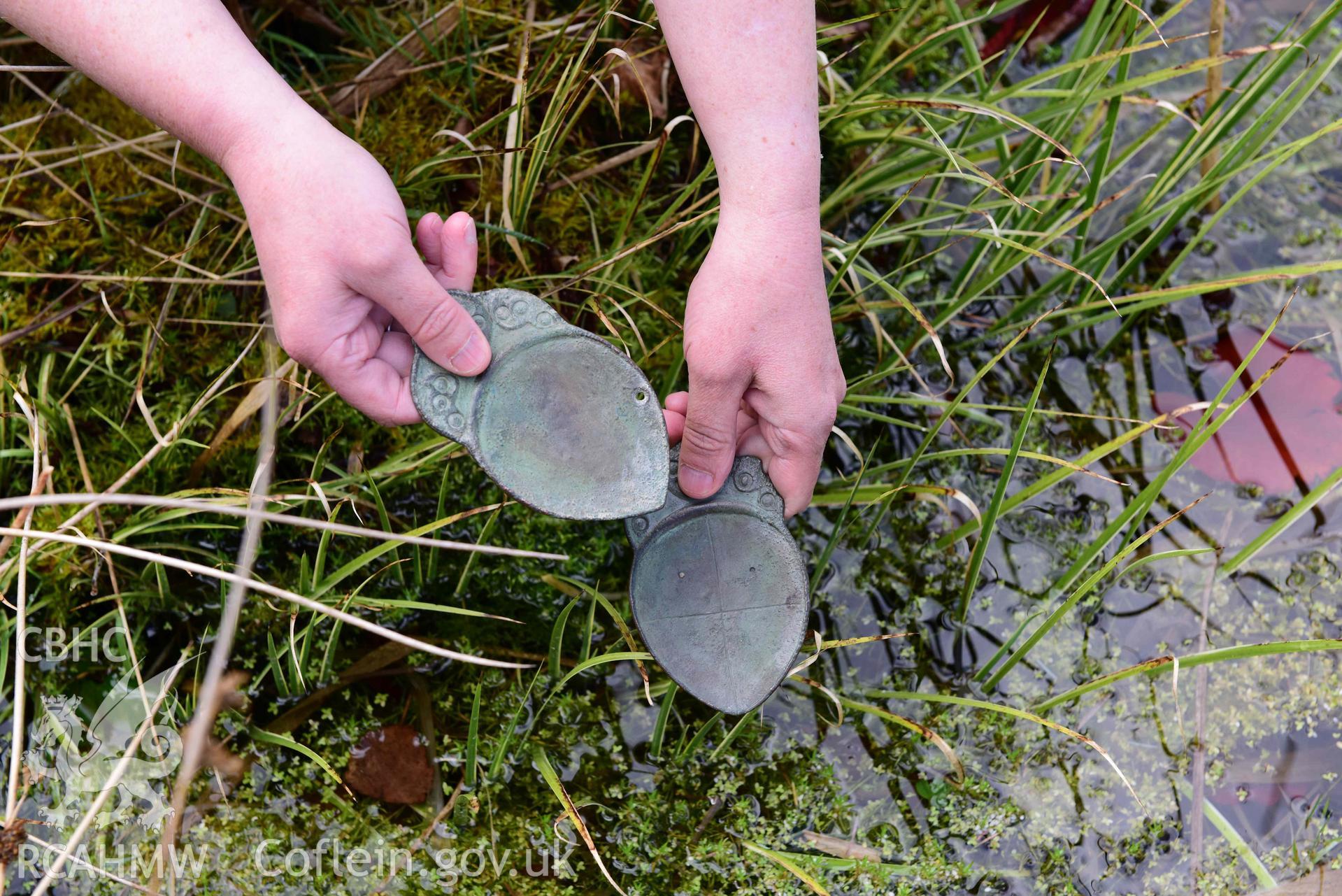 Electrotype replicas of the Penbryn Spoons, loaned from Amgueddfa Ceredigion Museum, photographed outdoors to show their imagined use at a sacred spring