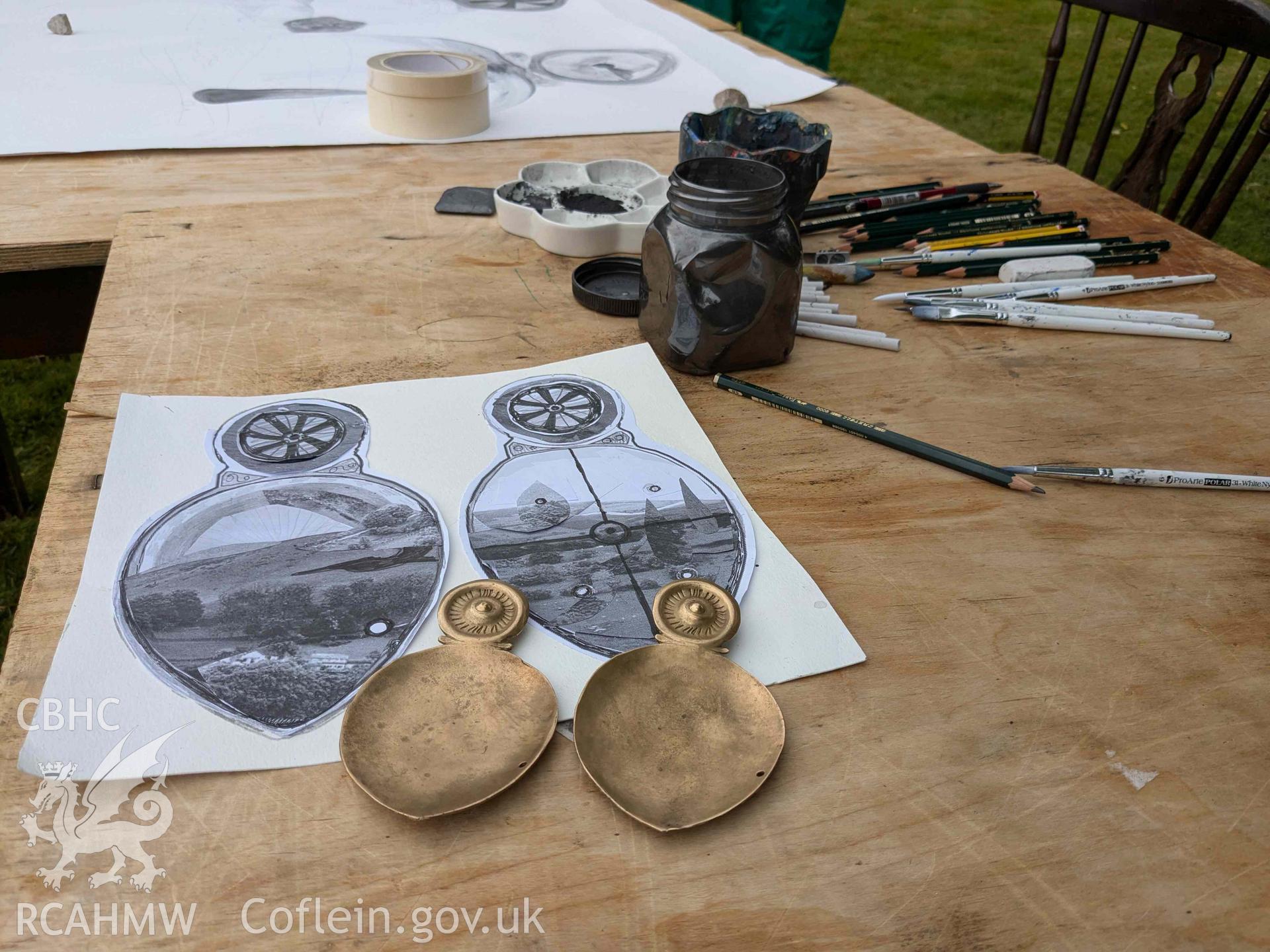 The Ffynogion spoons. Modern replicas from Denbighshire County Council's Heather and Hillforts education collection viewed with work by artist Olivia Hicks RA at the Ruthin International Arts Festival, June 2024.