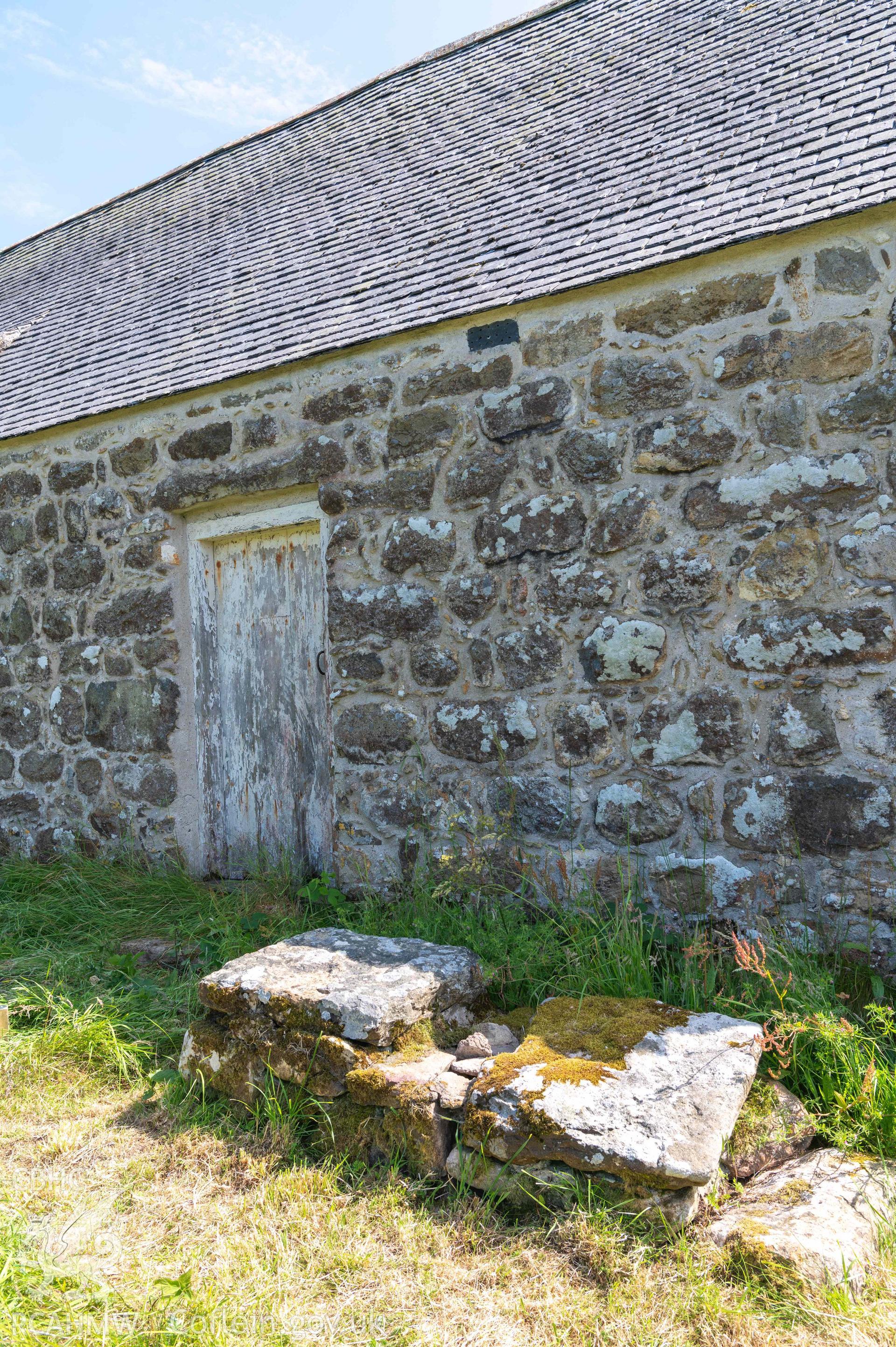 Capel Newydd - View of the West entrance, pile of rock slabs in the foreground, taken from North-West