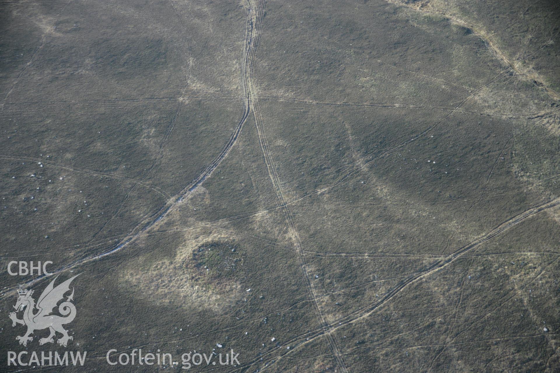 RCAHMW colour oblique aerial photograph of Rhossili Down Cairn V from the north-east, with a ring cairn beyond. Taken on 26 January 2006 by Toby Driver.