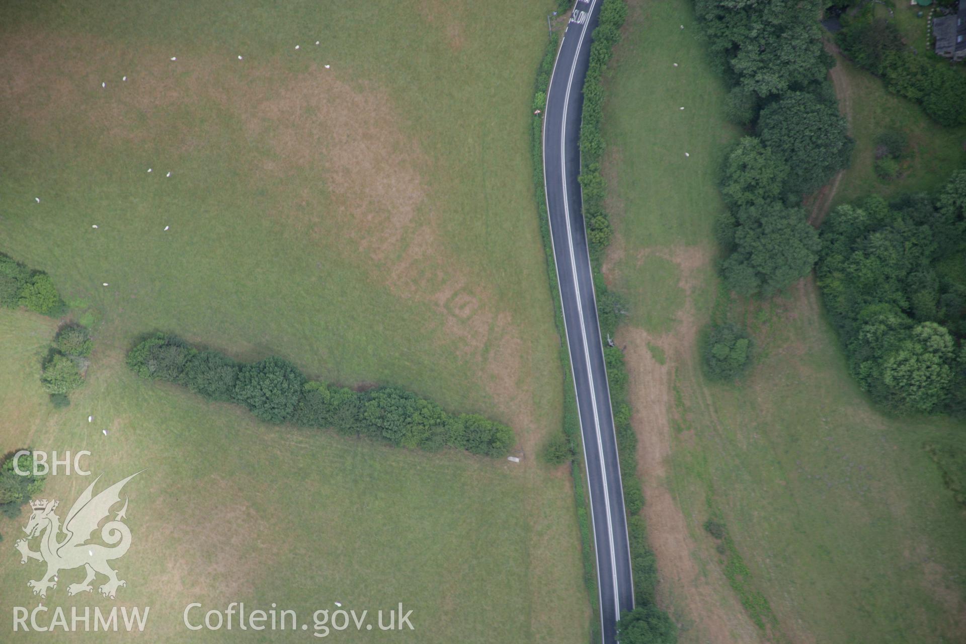 RCAHMW colour oblique aerial photograph of Druid Square Barrows and the Roman road. Taken on 31 July 2006 by Toby Driver.