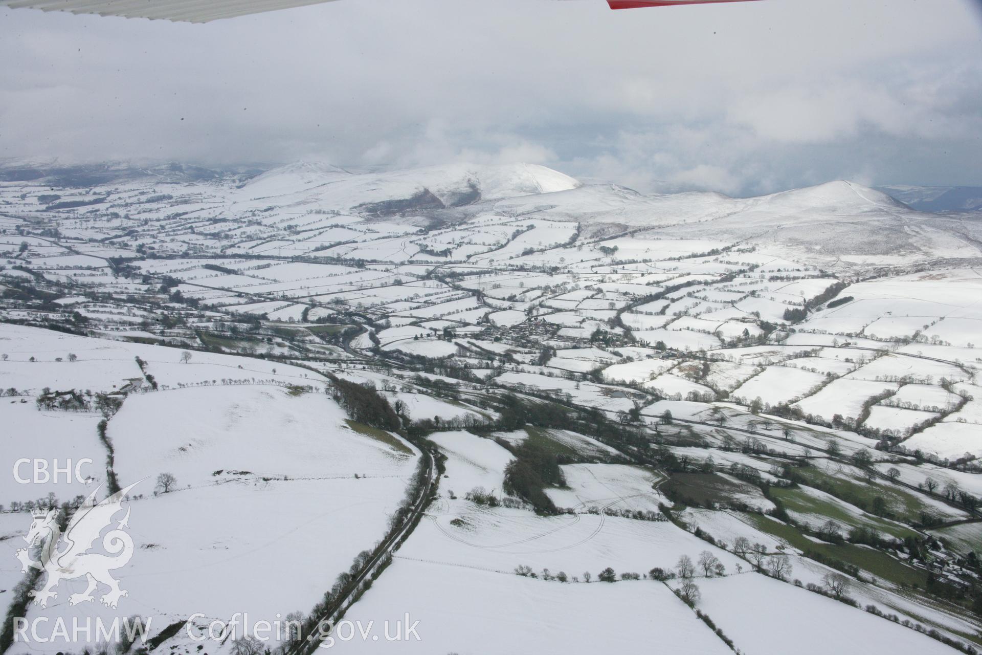 RCAHMW colour oblique aerial photograph of Moel-y-Gaer Hillfort, Llantysilio in winter landscape from the south-west. Taken on 06 March 2006 by Toby Driver.