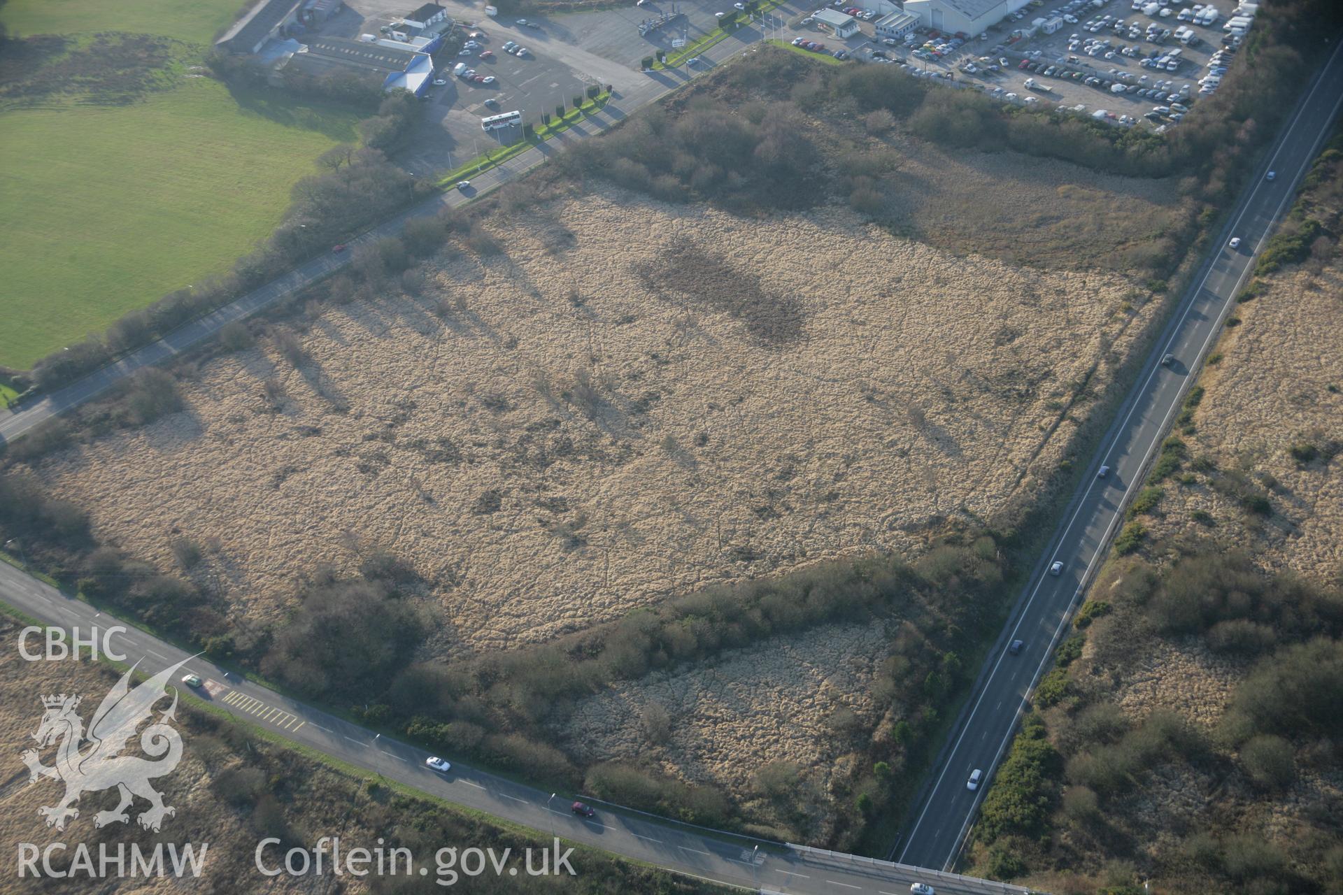 RCAHMW colour oblique aerial photograph of Mynydd Carn-Goch Roman Camp II, viewed from the north-east. Taken on 26 January 2006 by Toby Driver.