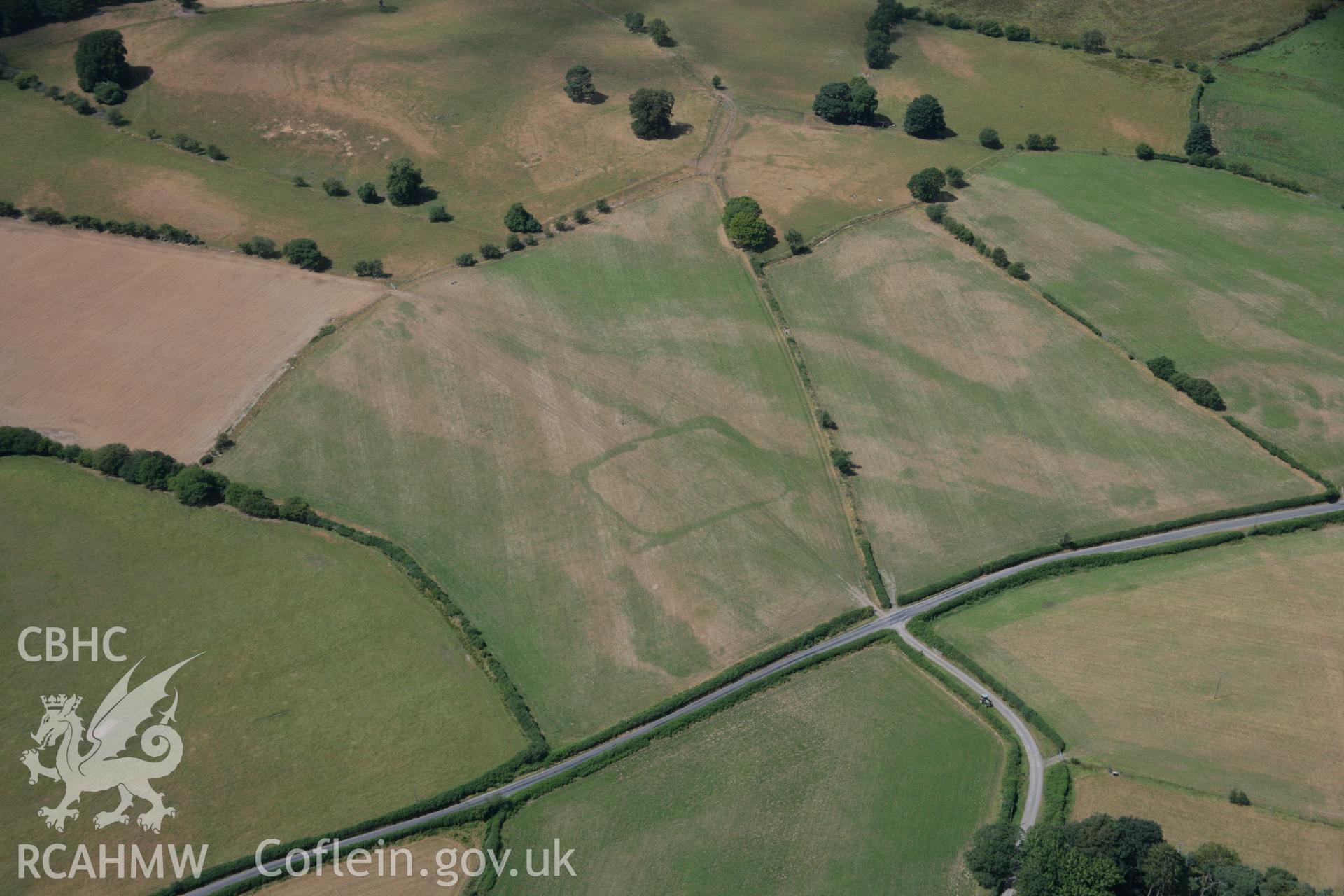 RCAHMW colour oblique aerial photograph of cropmark enclosures west of Caerau. Taken on 27 July 2006 by Toby Driver.