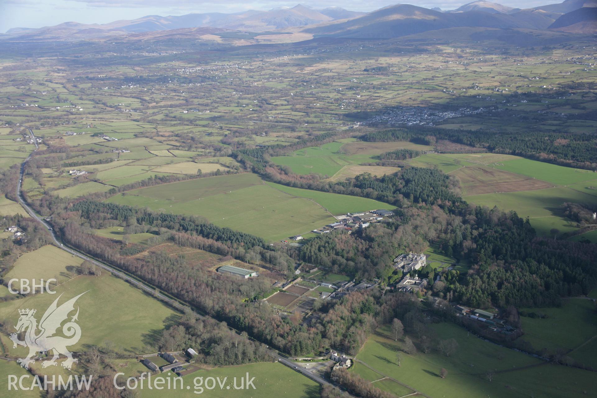 RCAHMW colour oblique aerial photograph of Glynllifon Park, Grounds and Gardens. A general view from the west. Taken on 09 February 2006 by Toby Driver.