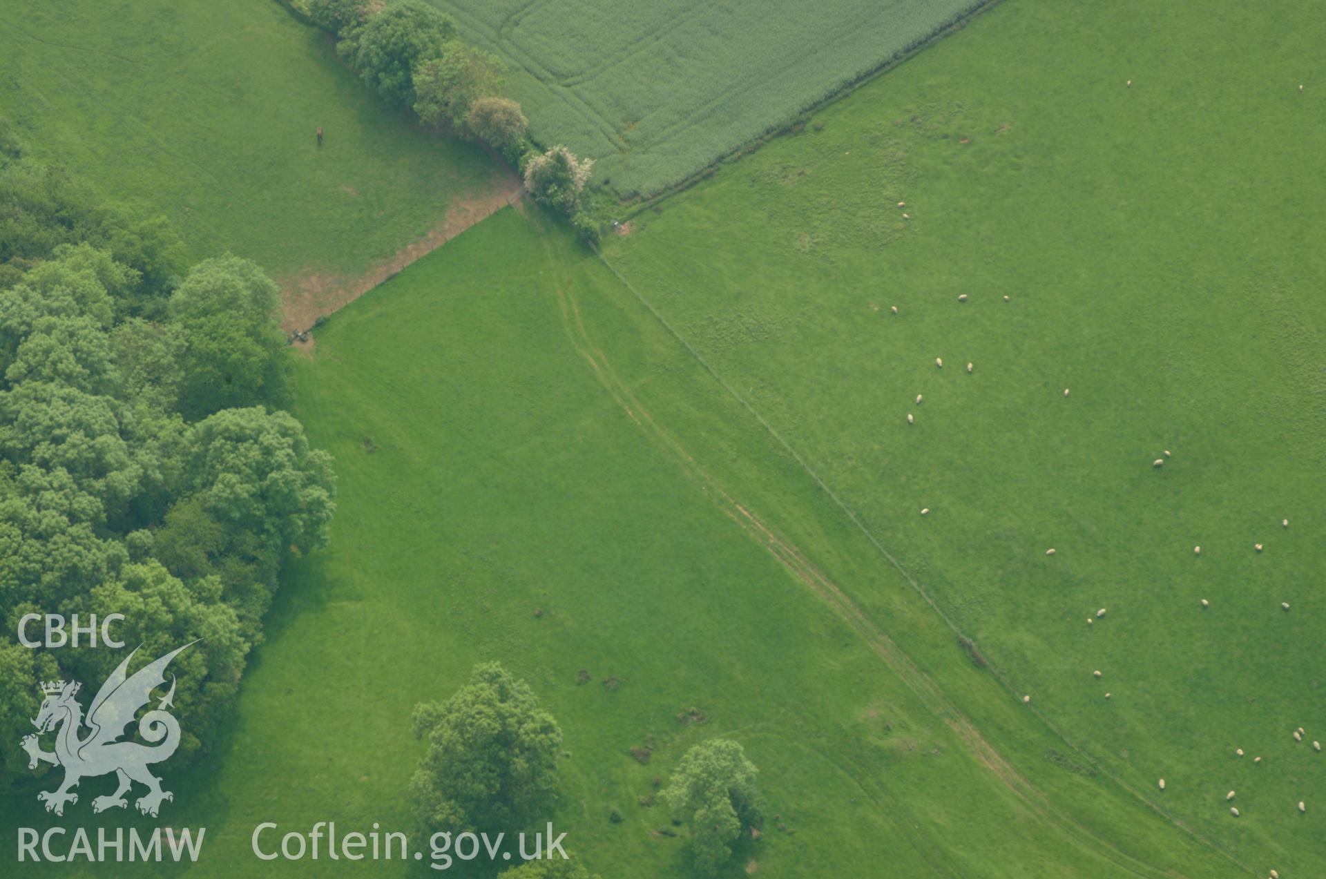 RCAHMW colour oblique aerial photograph showing southern end of Penhow Village Earthworks. Taken on 26 May 2004 by Toby Driver