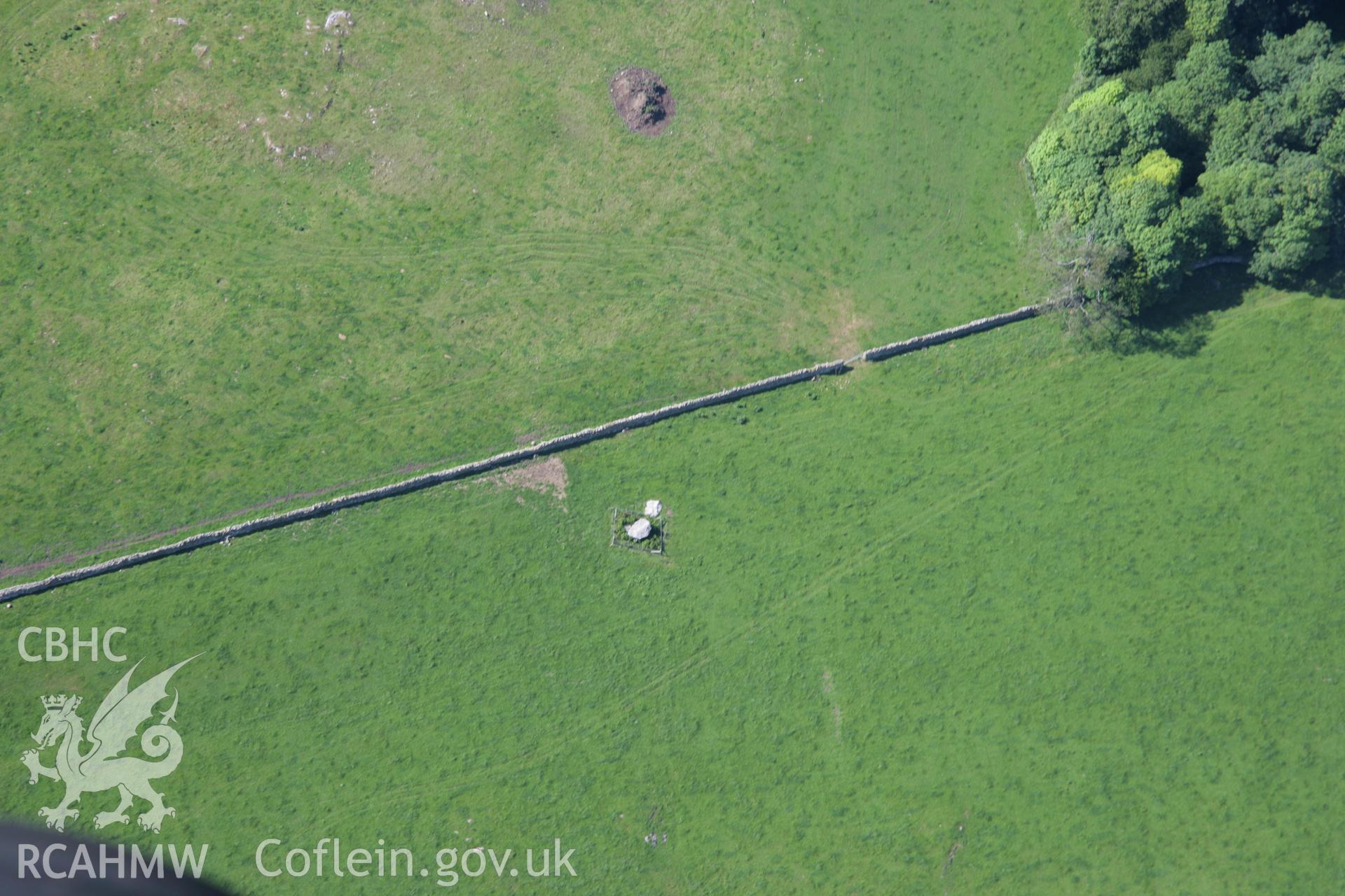 RCAHMW colour oblique aerial photograph of Cefnamwlch Burial Chamber (Coetan Arthur) from the south-east. Taken on 14 June 2006 by Toby Driver.