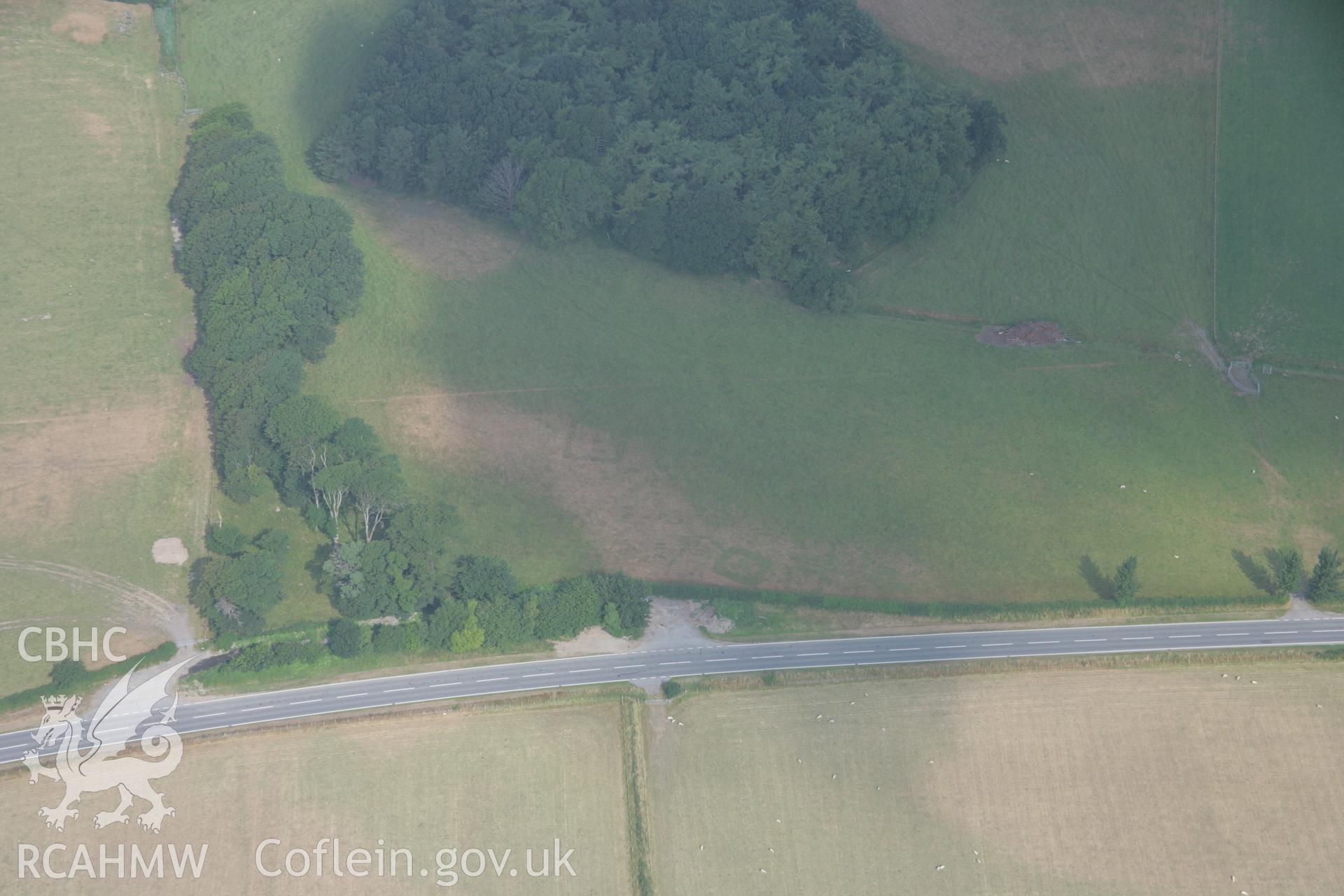 RCAHMW colour oblique aerial photograph of cropmark features north of Croes Faen possibly representing early Medieval Barrows. Taken on 21 July 2006 by Toby Driver.