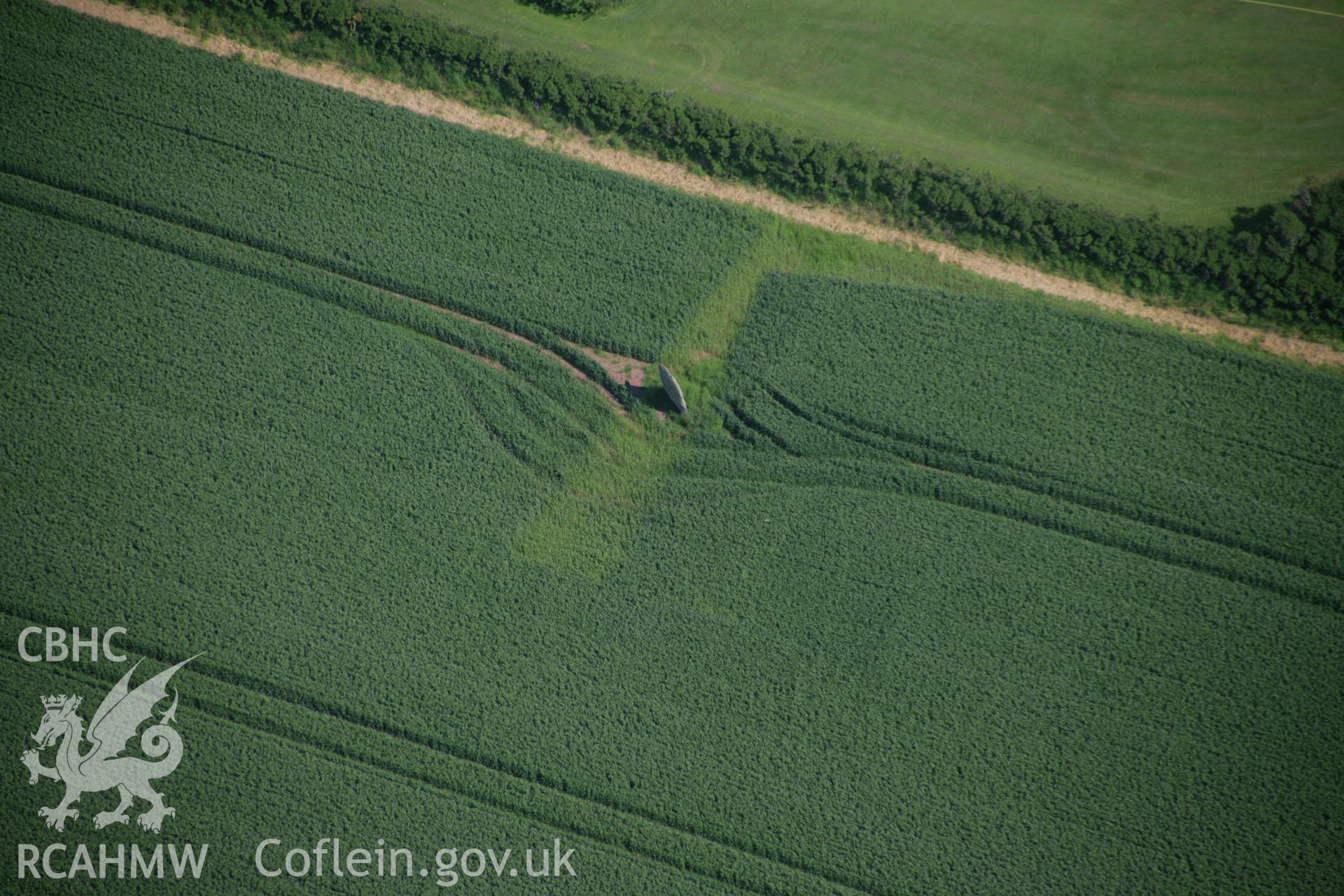 RCAHMW colour oblique aerial photograph of standing stone at Longstone, Mabesgate, St Ishmaels, viewed from the north-west. Taken on 08 June 2006 by Toby Driver.