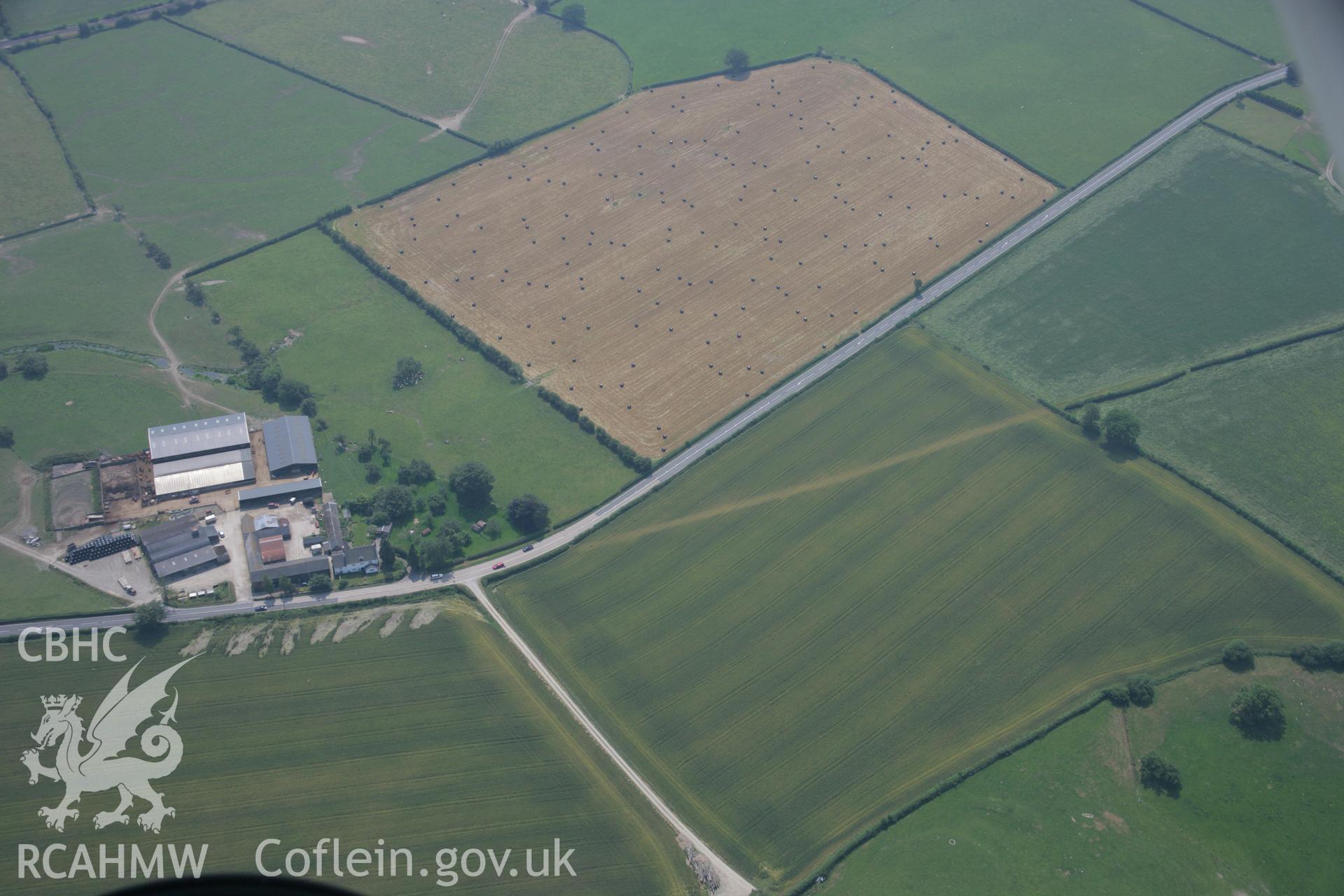 RCAHMW colour oblique aerial photograph of a section of Roman Road at Maes-Mawr Hall. Taken on 04 July 2006 by Toby Driver.