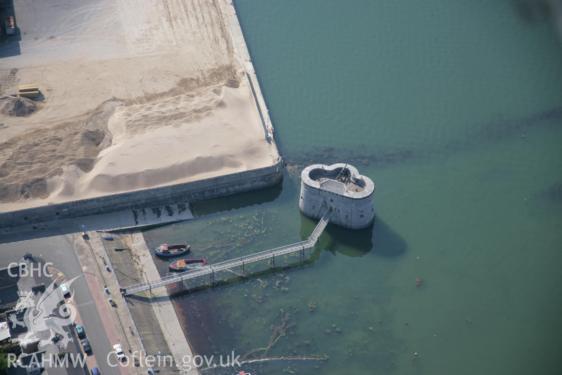 RCAHMW colour oblique aerial photograph of the eastern martello tower at Pembroke Dockyard viewed from the east. Taken on 08 June 2006 by Toby Driver.