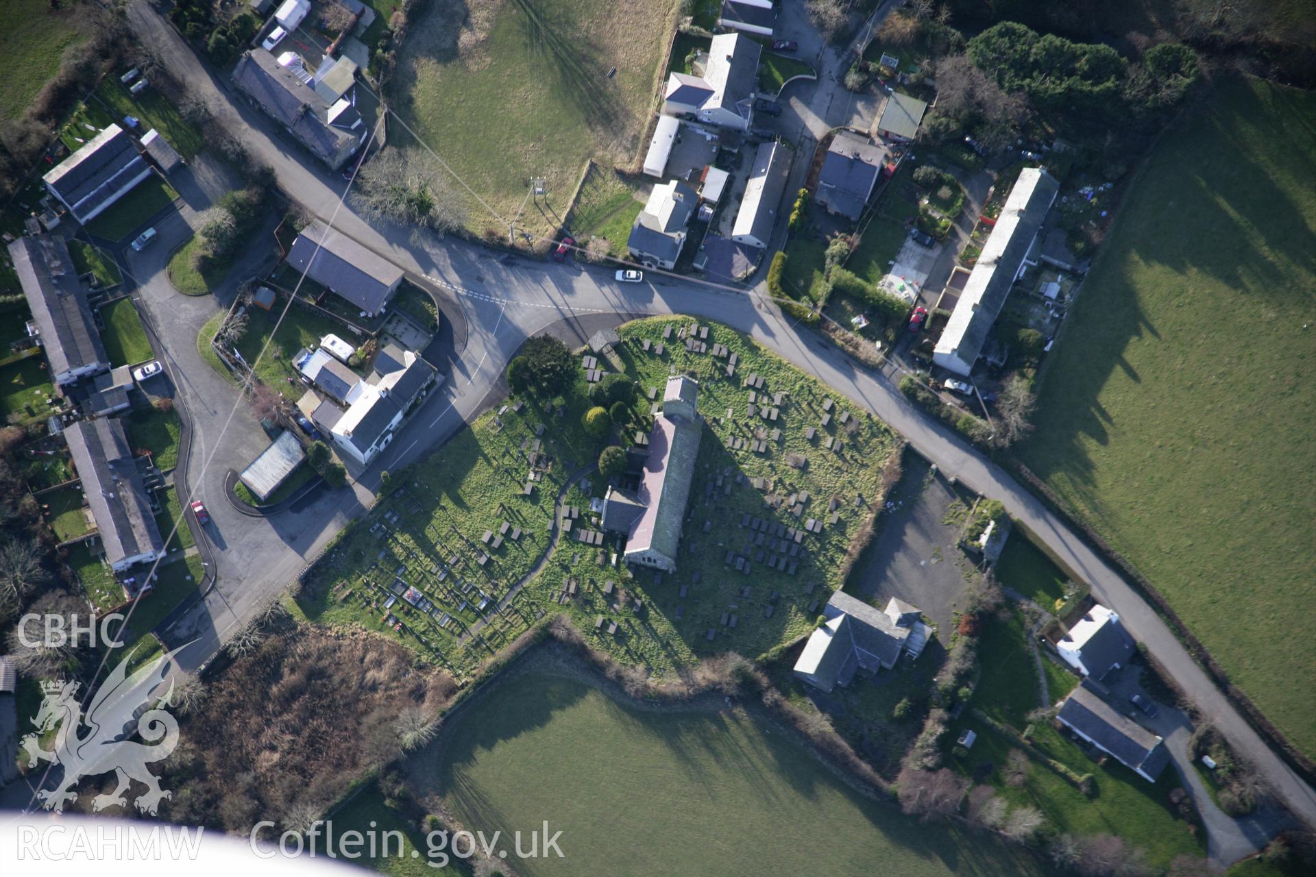 RCAHMW colour oblique aerial photograph of Holy Cross Church, Llannor, view from the north - east. Taken on 09 February 2006 by Toby Driver.