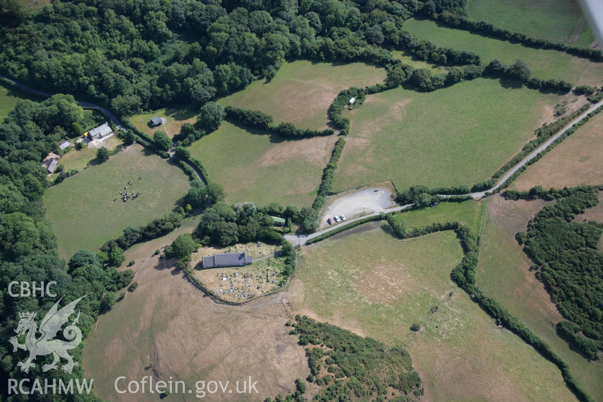 RCAHMW colour oblique aerial photograph of an enclosure to the southwest of St Michael's Church. Taken on 27 July 2006 by Toby Driver.