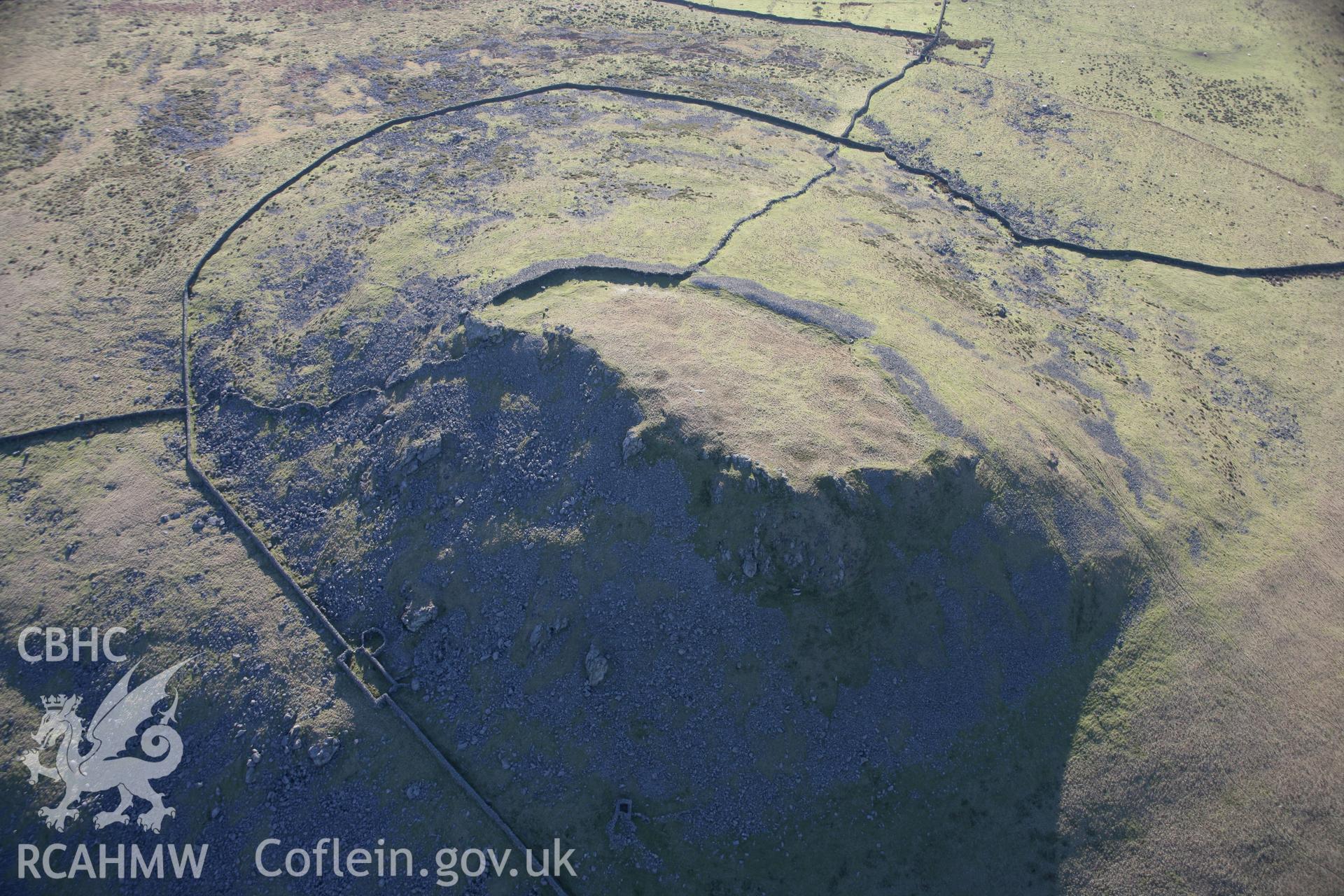 RCAHMW colour oblique aerial photograph of Pen-y-Gaer Hillfort, viewed from the north-east. Taken on 09 February 2006 by Toby Driver.
