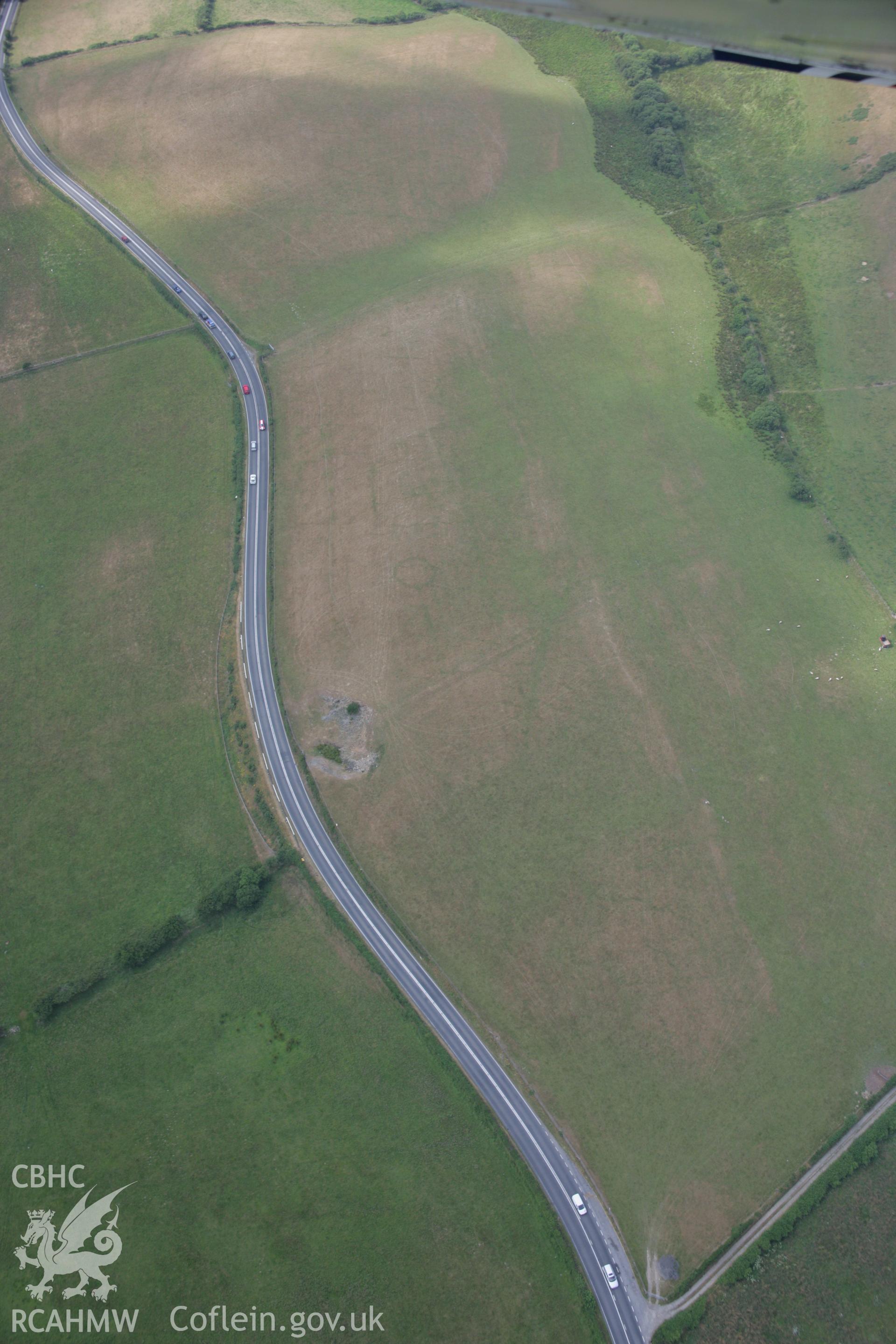 RCAHMW colour oblique aerial photograph of a cropmark ring-ditch southwest of Berth-Rhys. Taken on 21 July 2006 by Toby Driver.