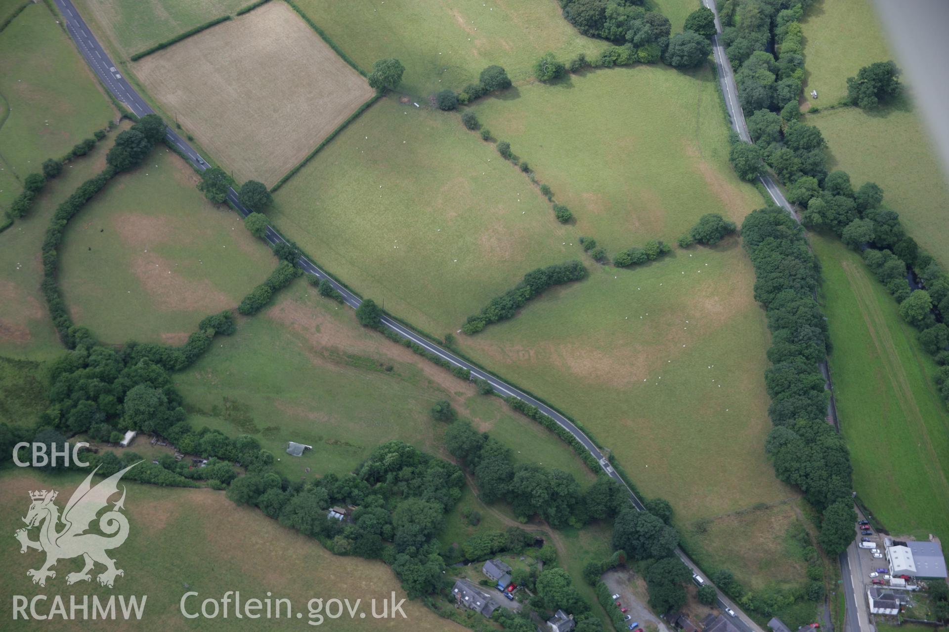 RCAHMW colour oblique aerial photograph of Druid Square Barrows and the Roman road. Taken on 31 July 2006 by Toby Driver.