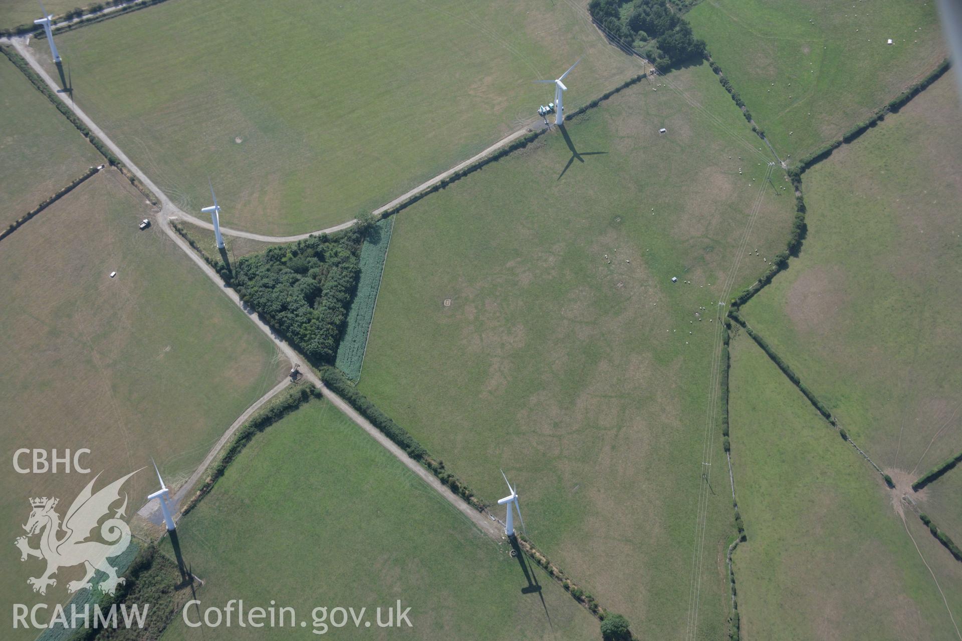 RCAHMW colour oblique aerial photograph of Trysglwyn Wind Farm, Rhosybol, showing indistinct cropmarks. Taken on 14 August 2006 by Toby Driver.