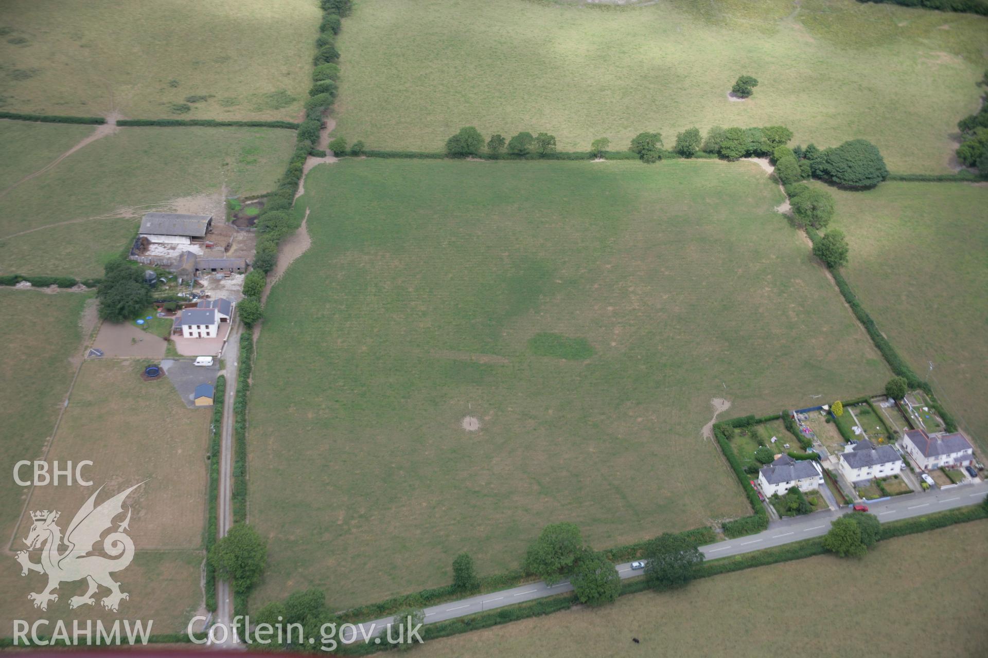 RCAHMW colour oblique aerial photograph of the Roman road west of Carmarthen at Presely View close to Brynhyfryd. The road shows as a parchmark. Taken on 27 July 2006 by Toby Driver.