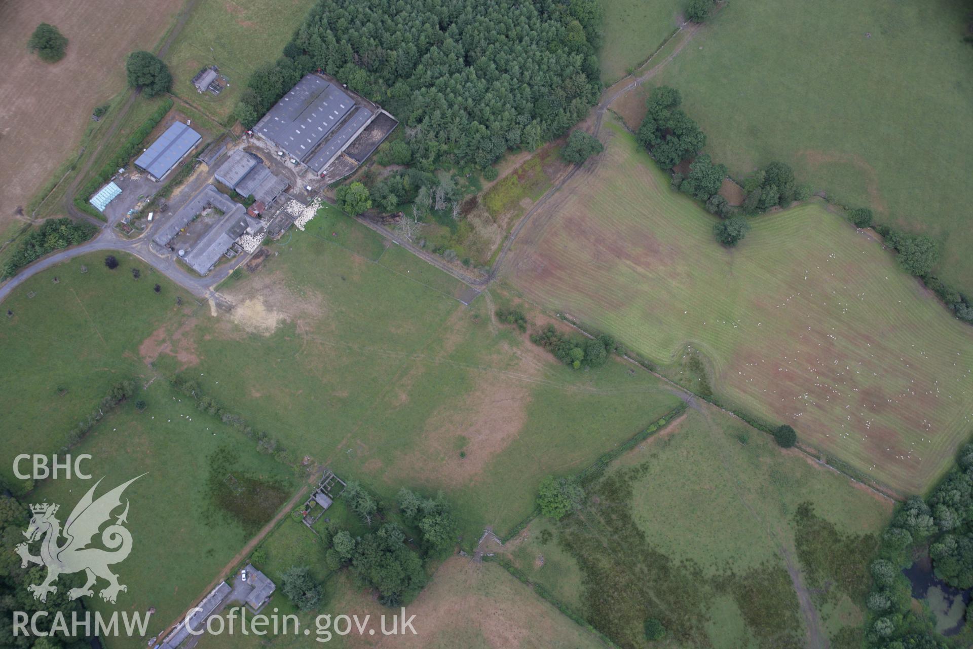 RCAHMW colour oblique aerial photograph of Rhiwlas Garden, Bala, fromm the south-west showing farm buildings, parchmarks of a silage bale stack and other marks. Taken on 31 July 2006 by Toby Driver.