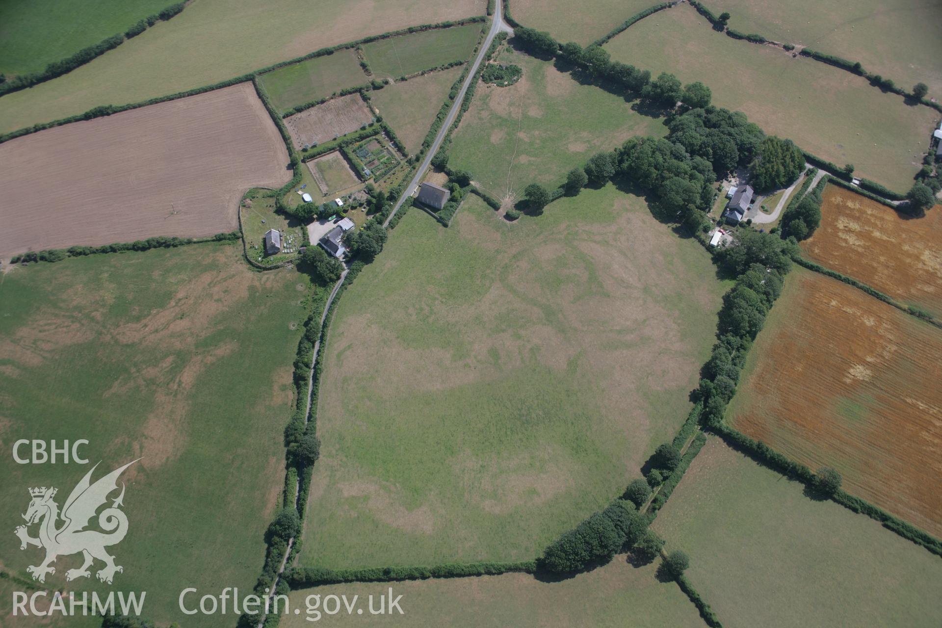 RCAHMW colour oblique aerial photograph of Capel Peniel, showing cropmark of defended enclosure and early church, viewed from the west. Taken on 03 August 2006 by Toby Driver