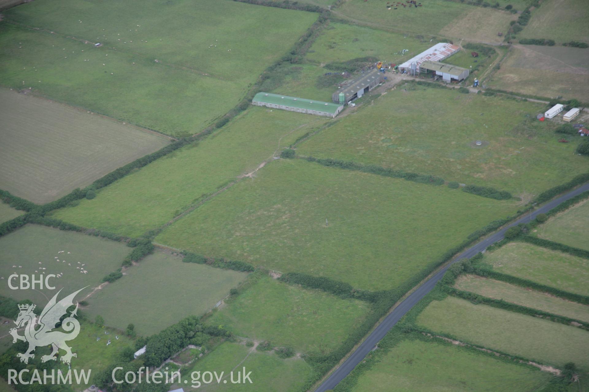 RCAHMW colour oblique aerial photograph of Llangwnadl standing stone, viewed from the south. Taken on 03 August 2006 by Toby Driver