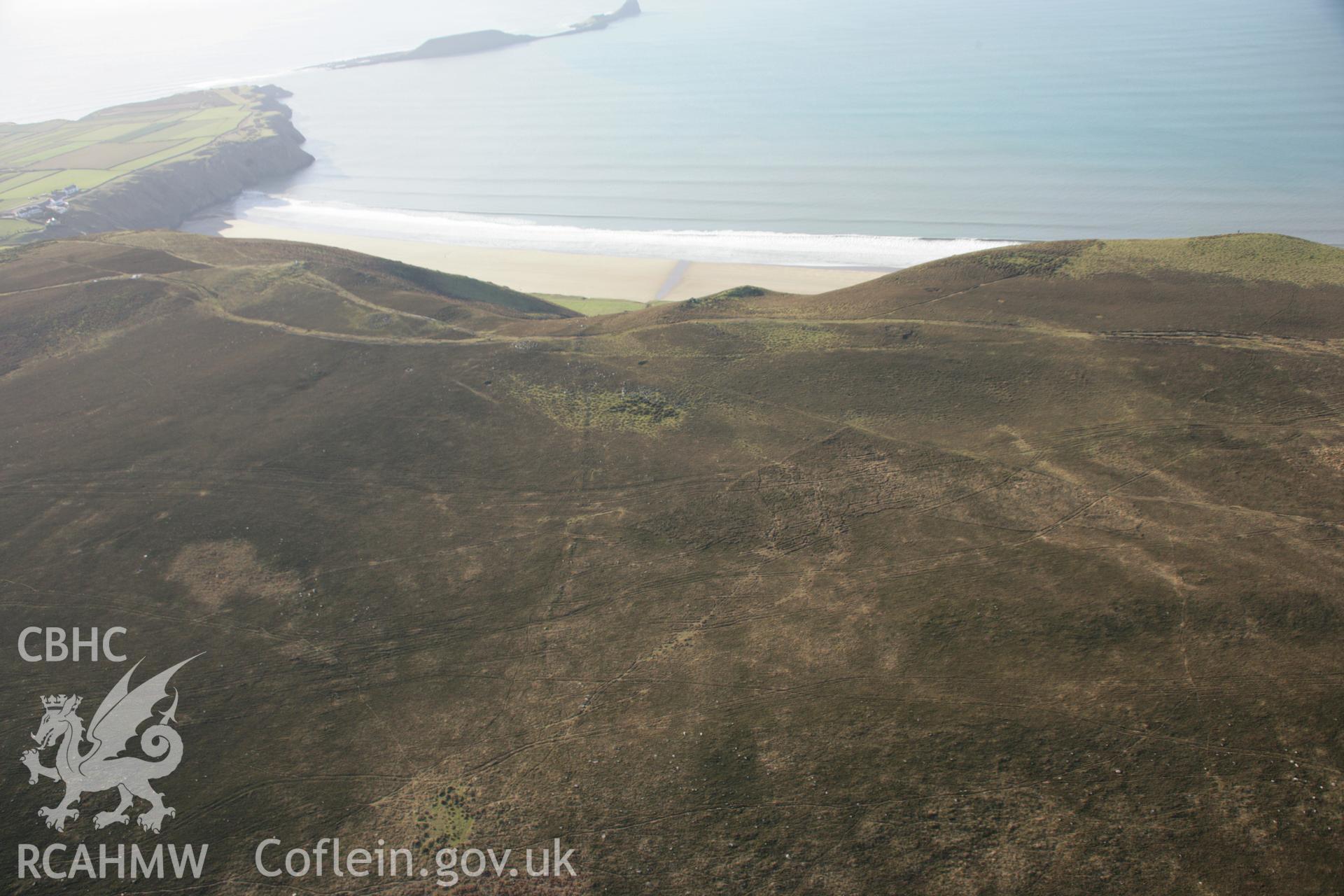 RCAHMW colour oblique aerial photograph of Rhossili Down pre-historic field boundary and cairns on Rhossili Down, viewed from the east. Taken on 26 January 2006 by Toby Driver