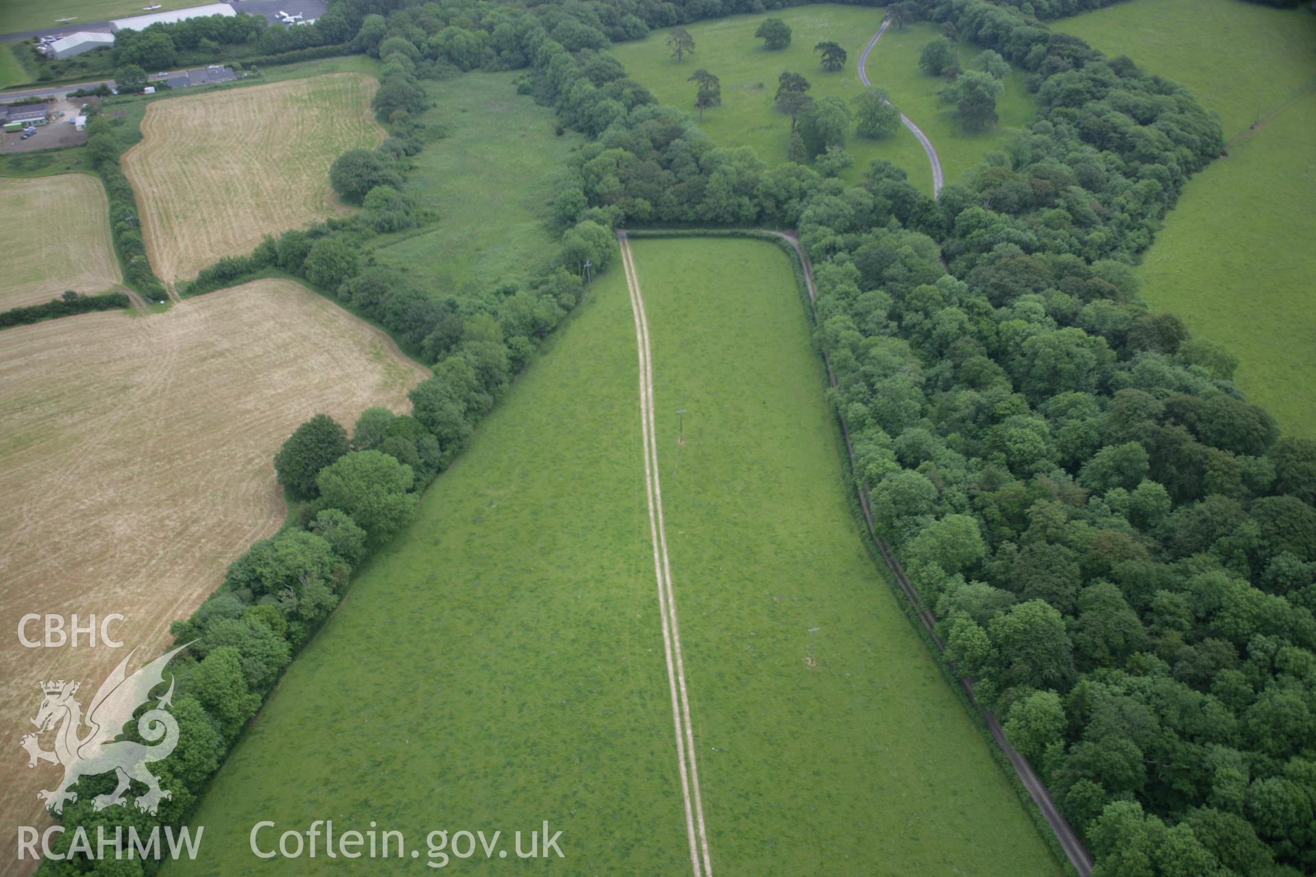 RCAHMW colour oblique aerial photograph of a pit circle 250m northeast of Cottesmore Farm. Taken on 15 June 2006 by Toby Driver.