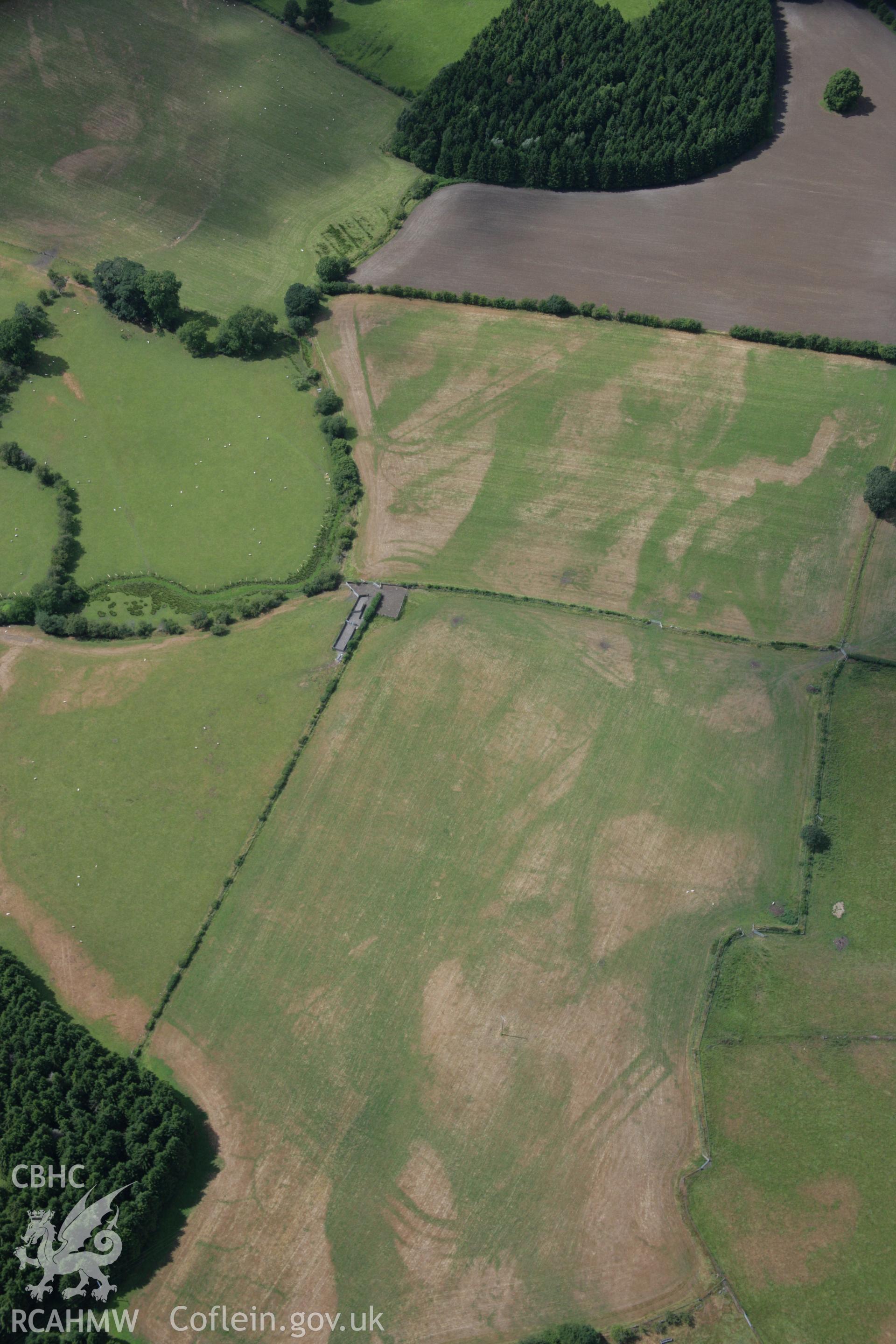 RCAHMW colour oblique aerial photograph of Llanfor Roman Military Complex visible in cropmarks, viewed from the south-east. Taken on 31 July 2006 by Toby Driver.