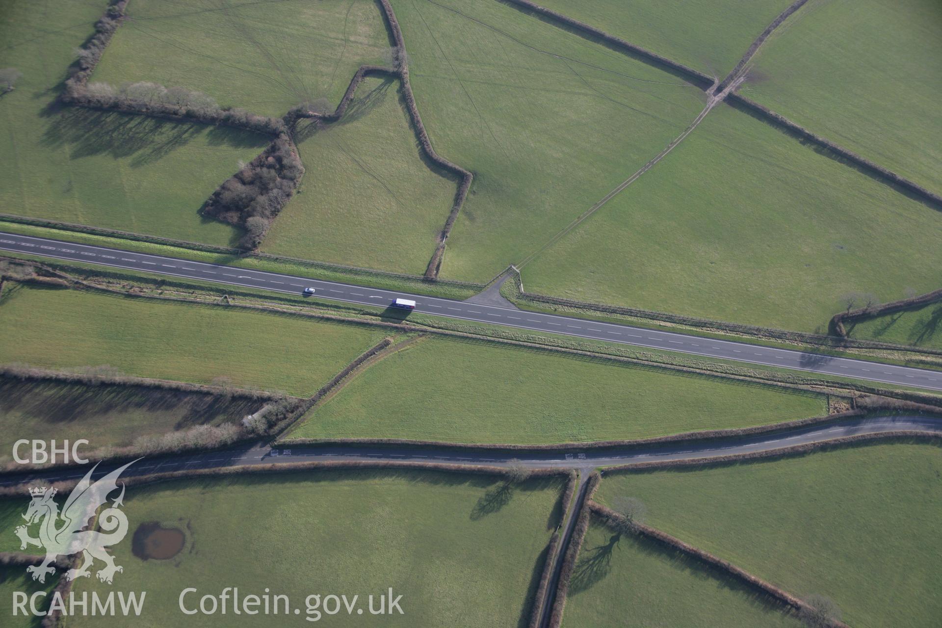 RCAHMW colour oblique aerial photograph of a round barrow 110m southwest of The Hoyles. Taken on 11 January 2006 by Toby Driver.