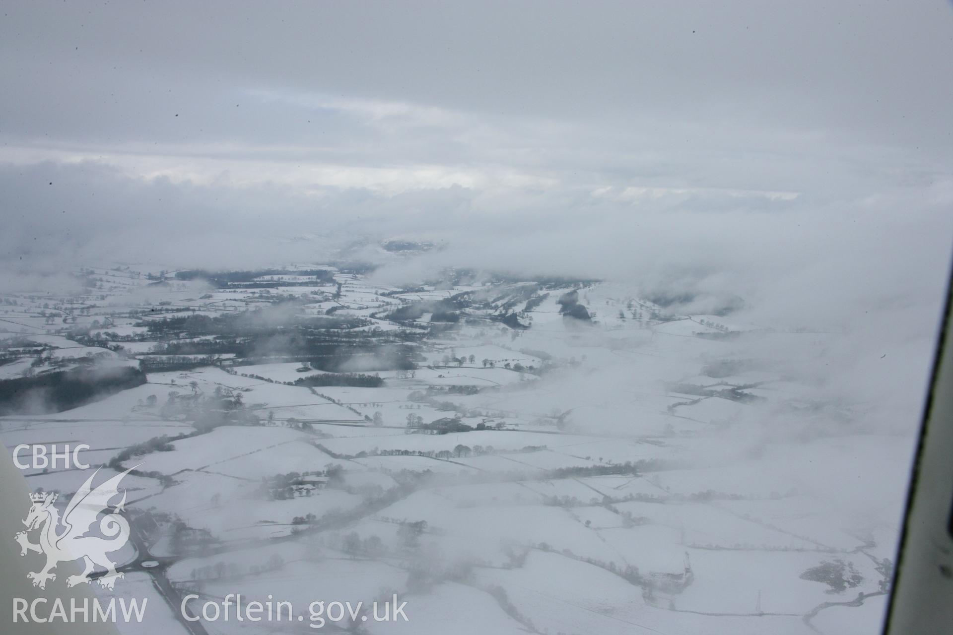 RCAHMW colour oblique aerial photograph of the landscape in winter close to St Tecla's Church, Llandegla. Taken on 06 March 2006 by Toby Driver.