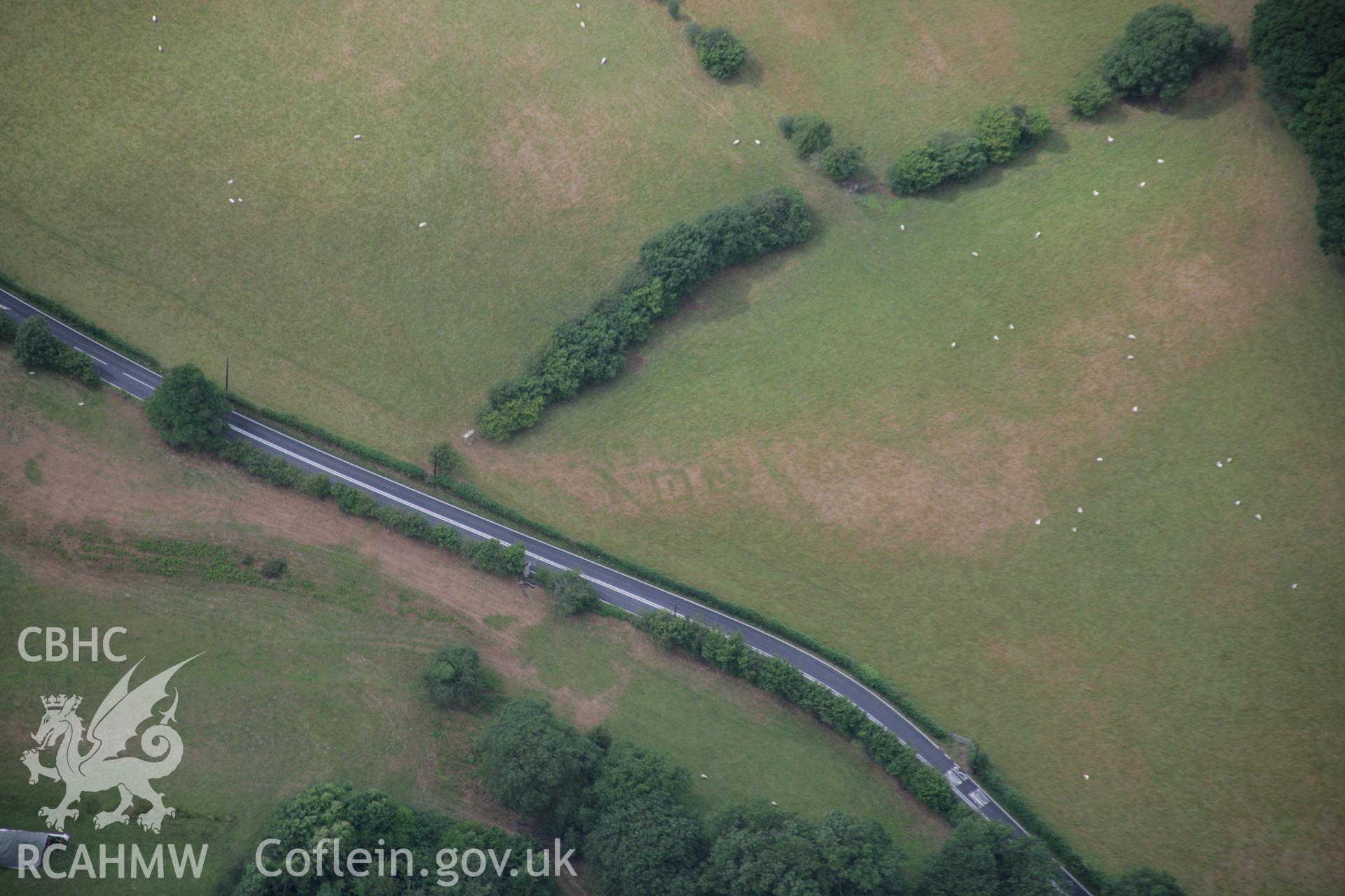 RCAHMW colour oblique aerial photograph of Druid Square Barrows and the Roman road. Taken on 31 July 2006 by Toby Driver.