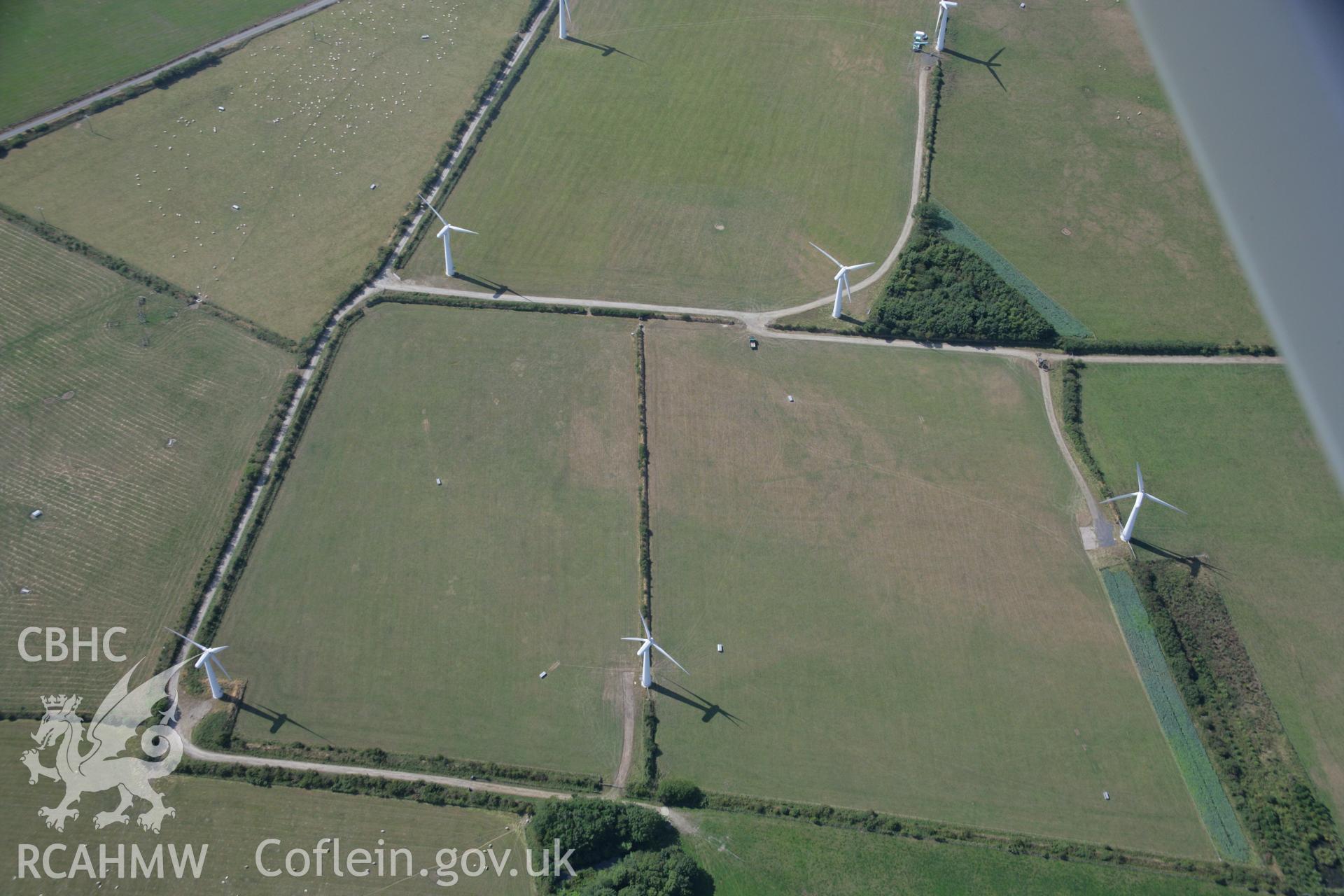 RCAHMW colour oblique aerial photograph of Trysglwyn Wind Farm, Rhosybol, showing indistinct cropmarks. Taken on 14 August 2006 by Toby Driver.