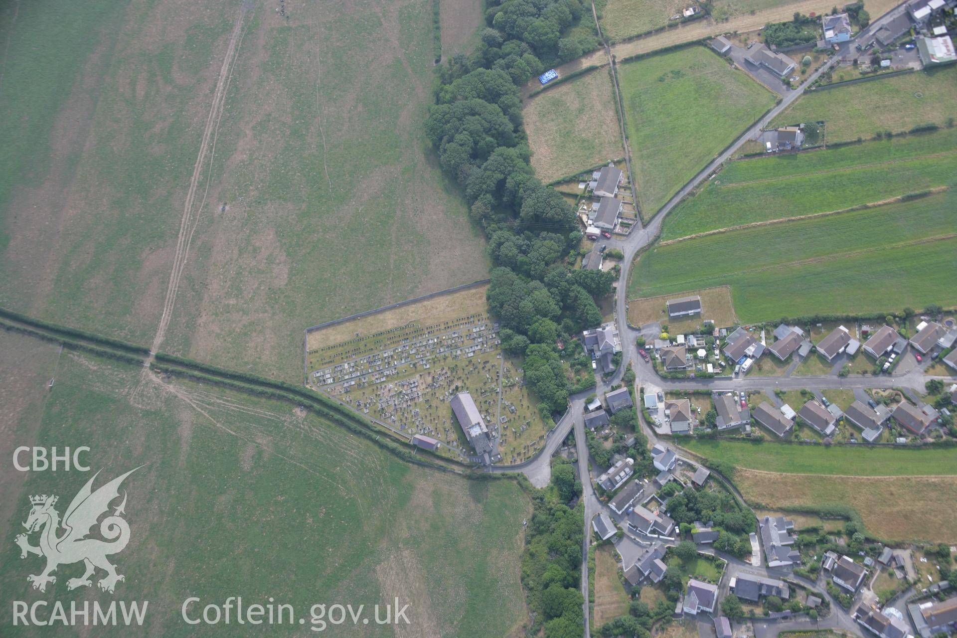 RCAHMW colour oblique aerial photograph of St Ffraid's or St Bride's Church, Llansantffraid. Taken on 21 July 2006 by Toby Driver.