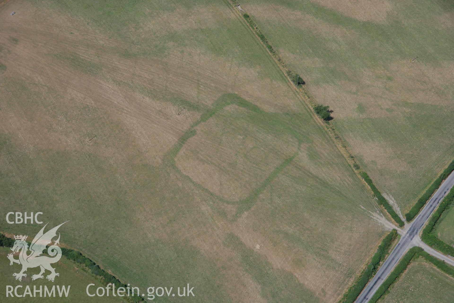 RCAHMW colour oblique aerial photograph of cropmark enclosures west of Caerau. Taken on 27 July 2006 by Toby Driver.