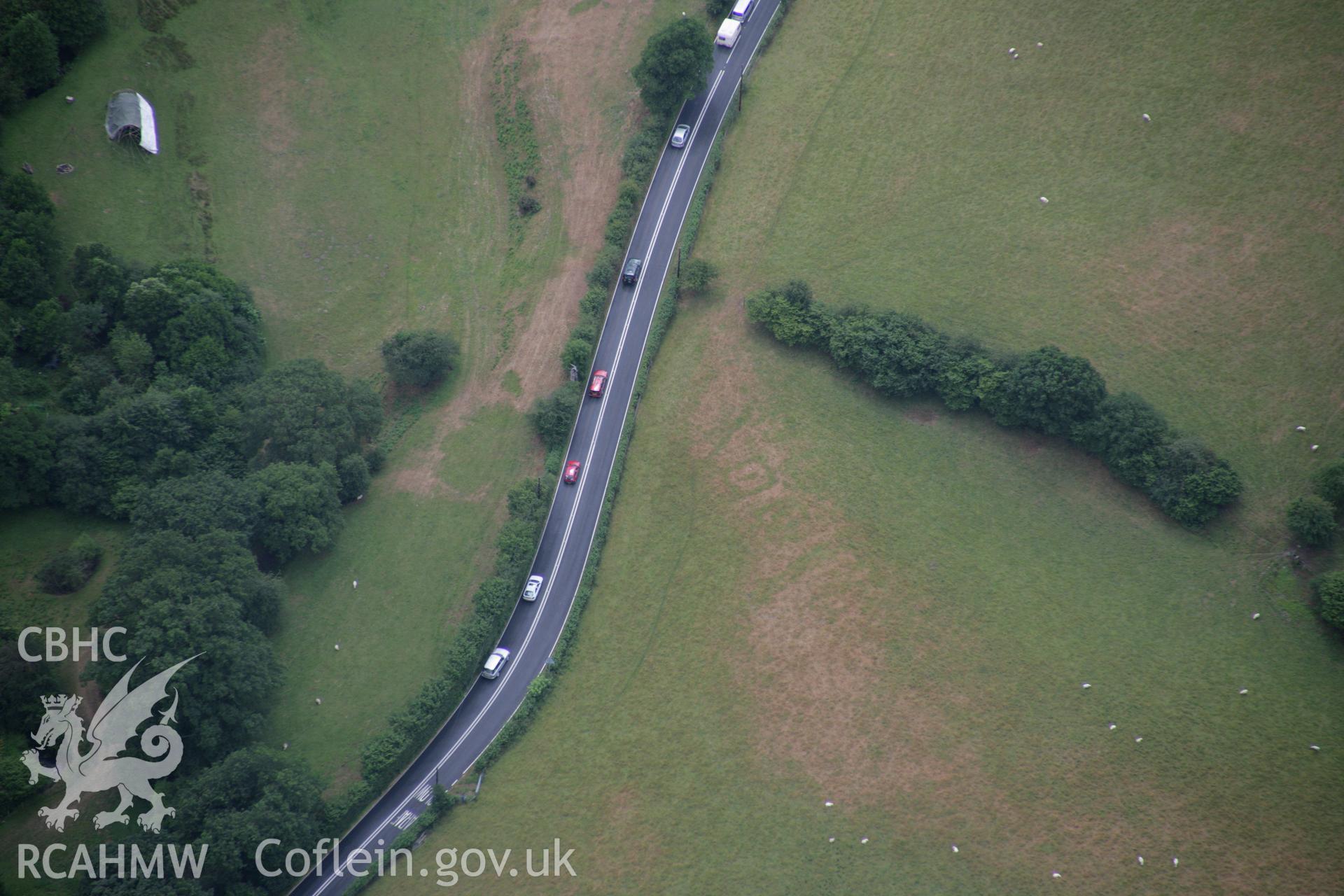 RCAHMW colour oblique aerial photograph of Druid Square Barrows and the Roman road. Taken on 31 July 2006 by Toby Driver.