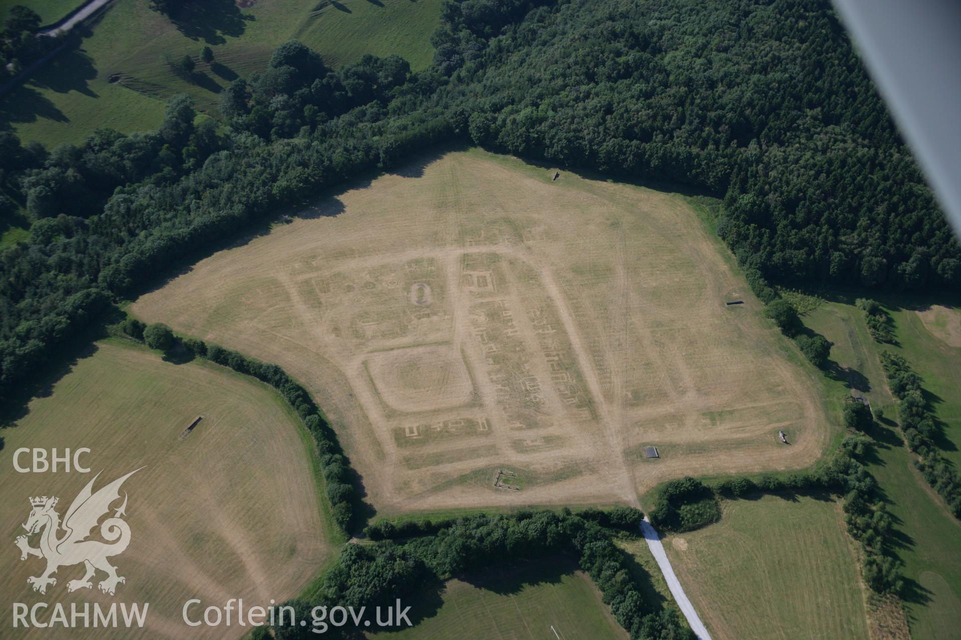 RCAHMW colour oblique aerial photograph of a section of Wat's Dyke from Coed Llys to the Chester to Holywell road. The site of a fair is also visible. Taken on 17 July 2006 by Toby Driver.