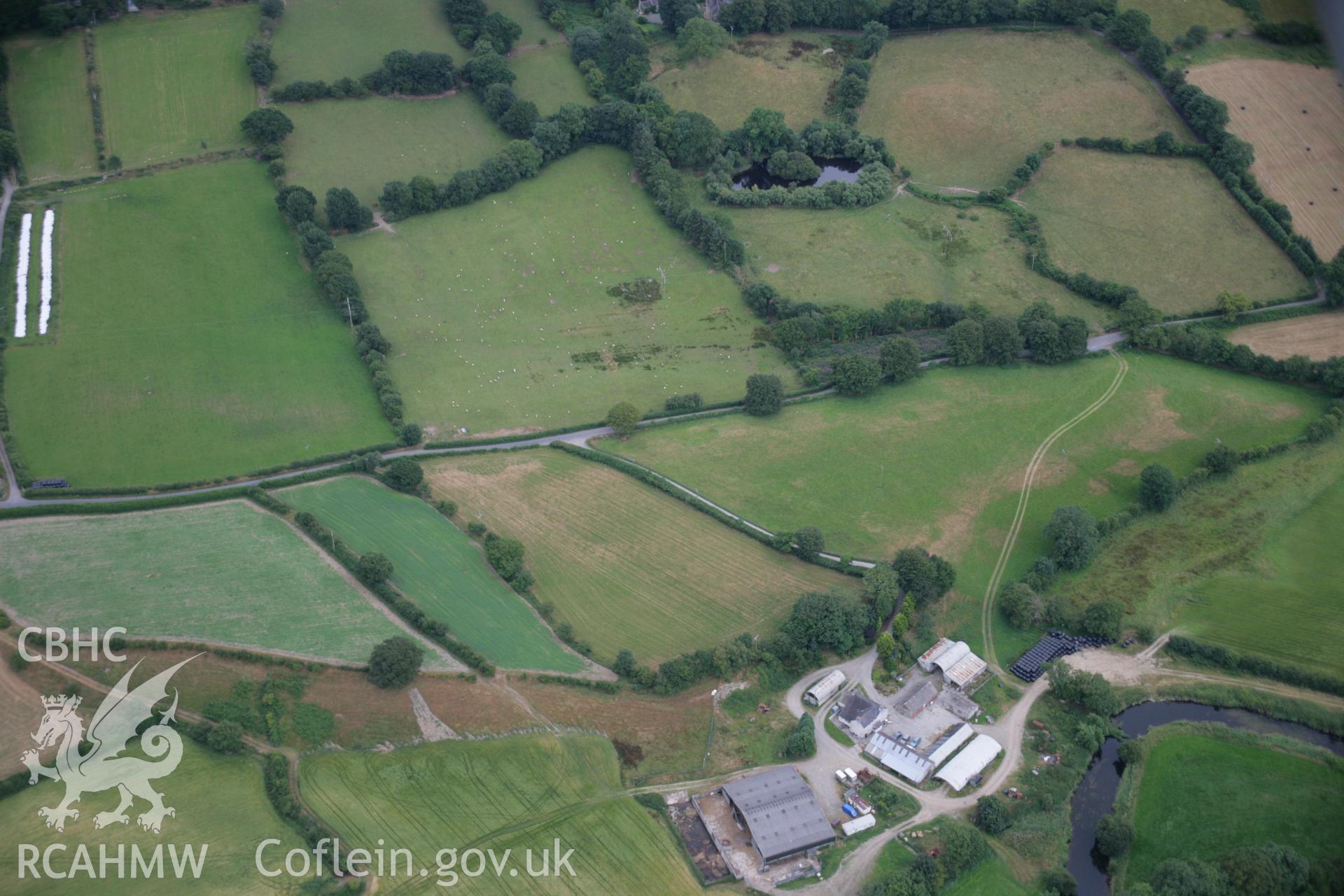 RCAHMW colour oblique aerial photograph of the Roman road between Llanio and Carmarthen, with the road showing as a parchmark. Taken on 27 July 2006 by Toby Driver.