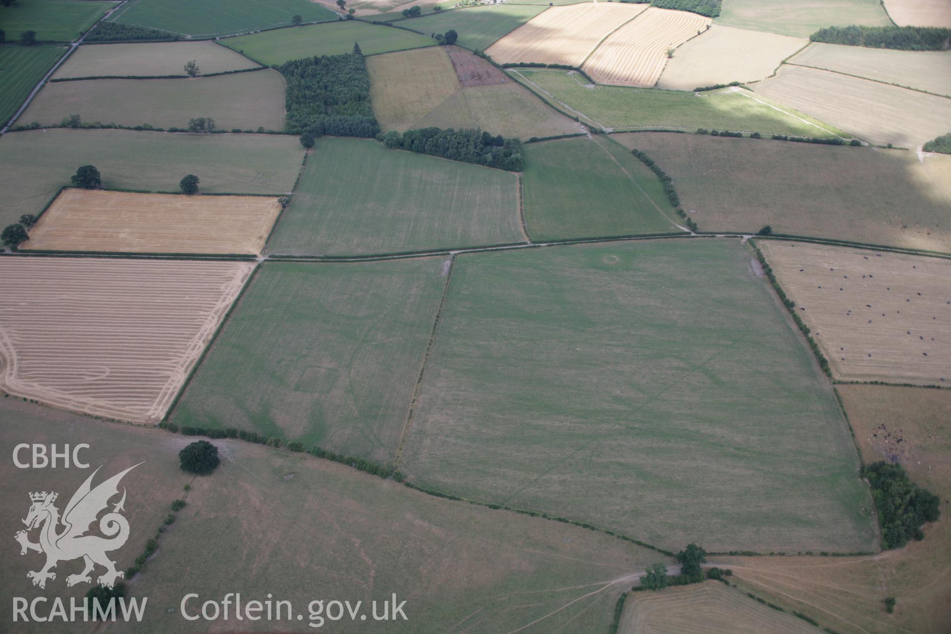 RCAHMW colour oblique aerial photograph of Hindwell Pallisaded Enclosure and Roman Camp. Taken on 27 July 2006 by Toby Driver.